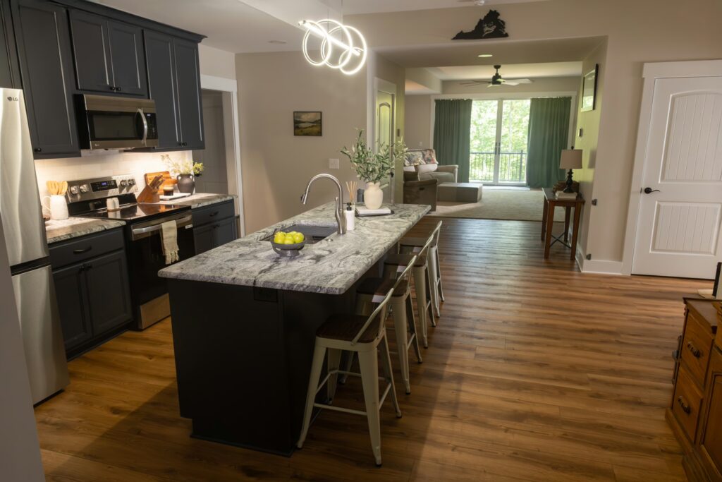 Modern kitchen with large island, pendant lighting, and hardwood floors