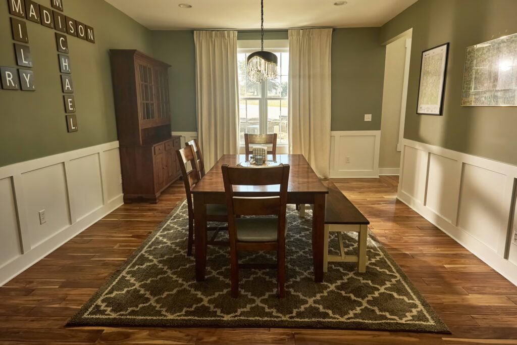 Formal dining room with hardwood floors and tall windows