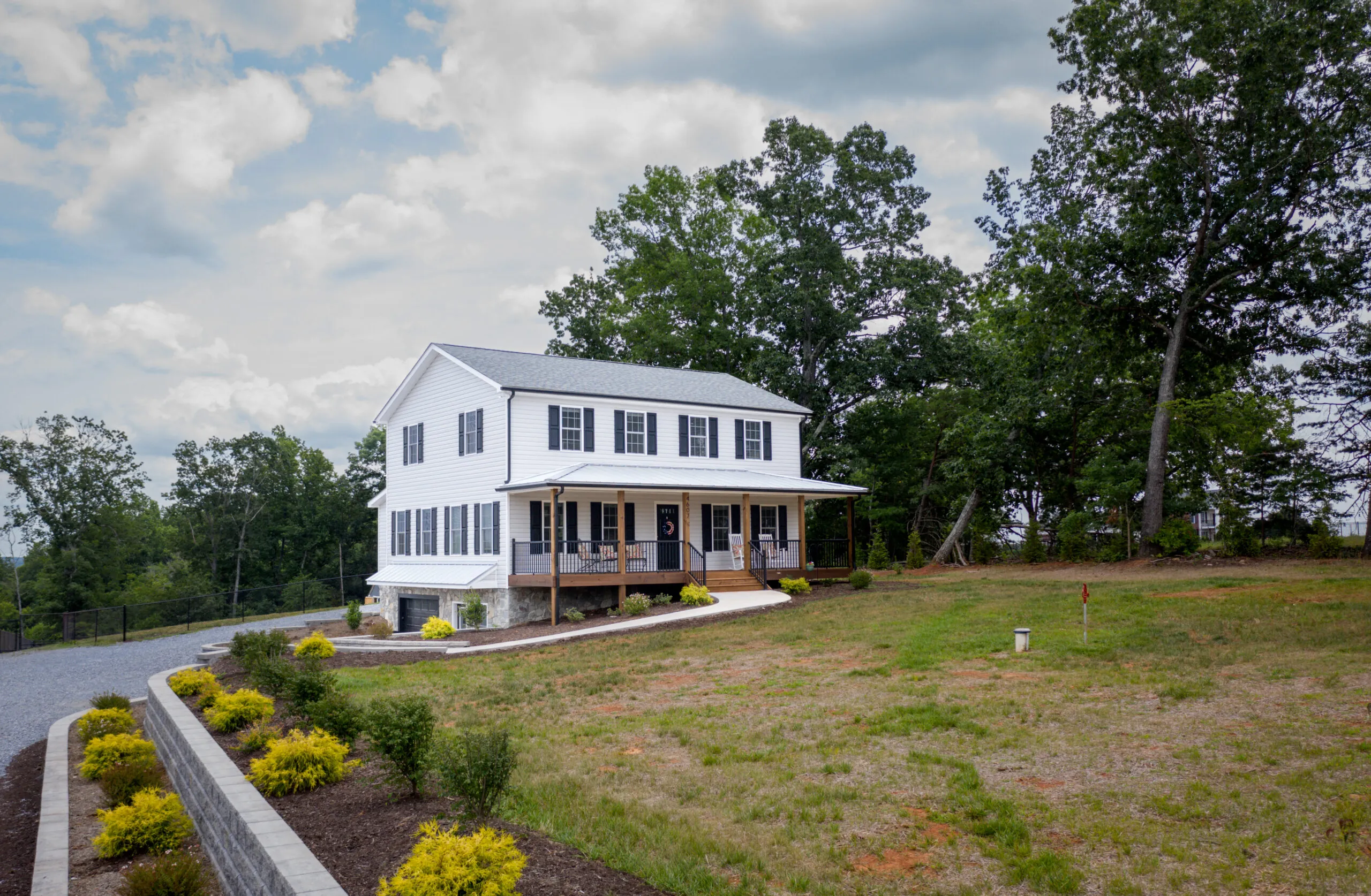 Front of the Timber Ridge Home with covered porch and landscaped lawn