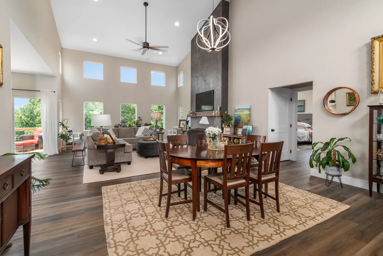 Open great room and dining area with tall ceiling and large windows in the LynBrook Home