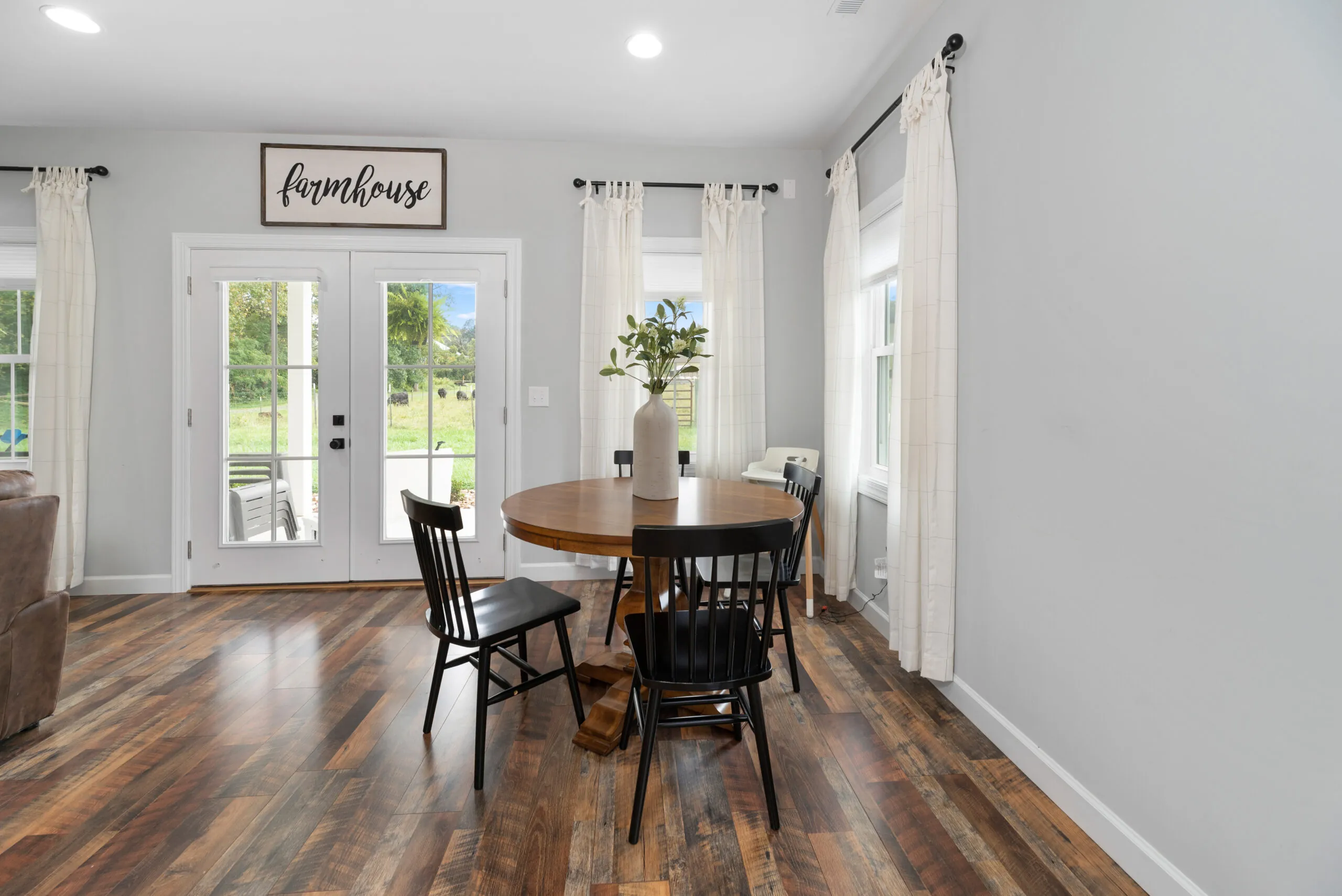 Dining area with round table and French doors in the Peters Creek Home
