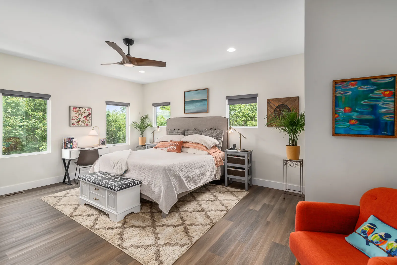 Primary bedroom with large windows and ceiling fan in the LynBrook Home