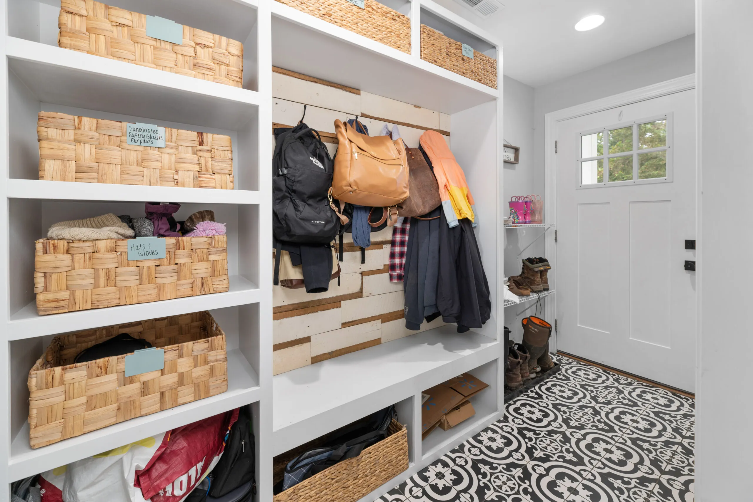 Mudroom with built-in cubbies, baskets and patterned tile floor in the Peters Creek Home