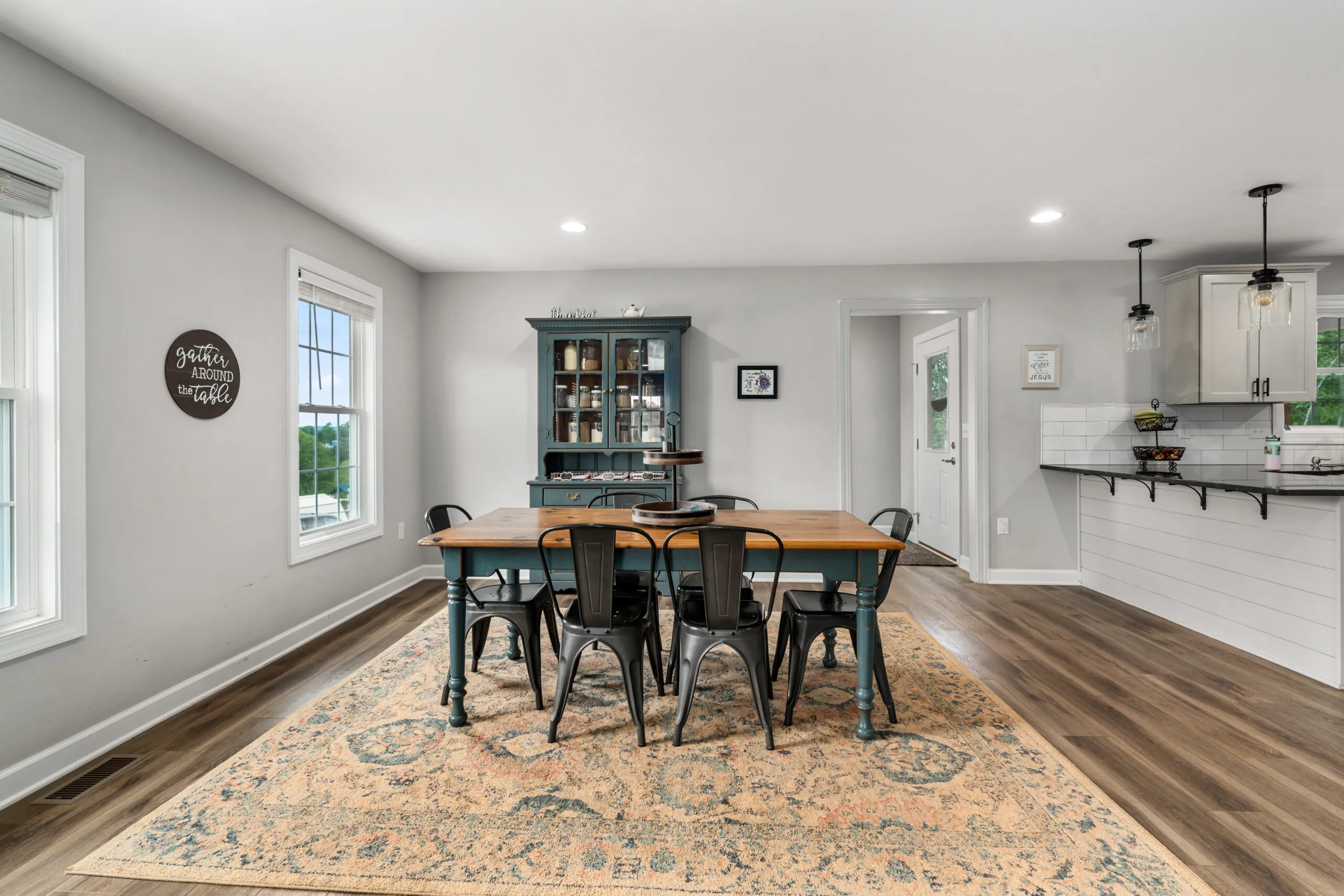 Dining room with farmhouse table and hutch in the Timber Ridge Home