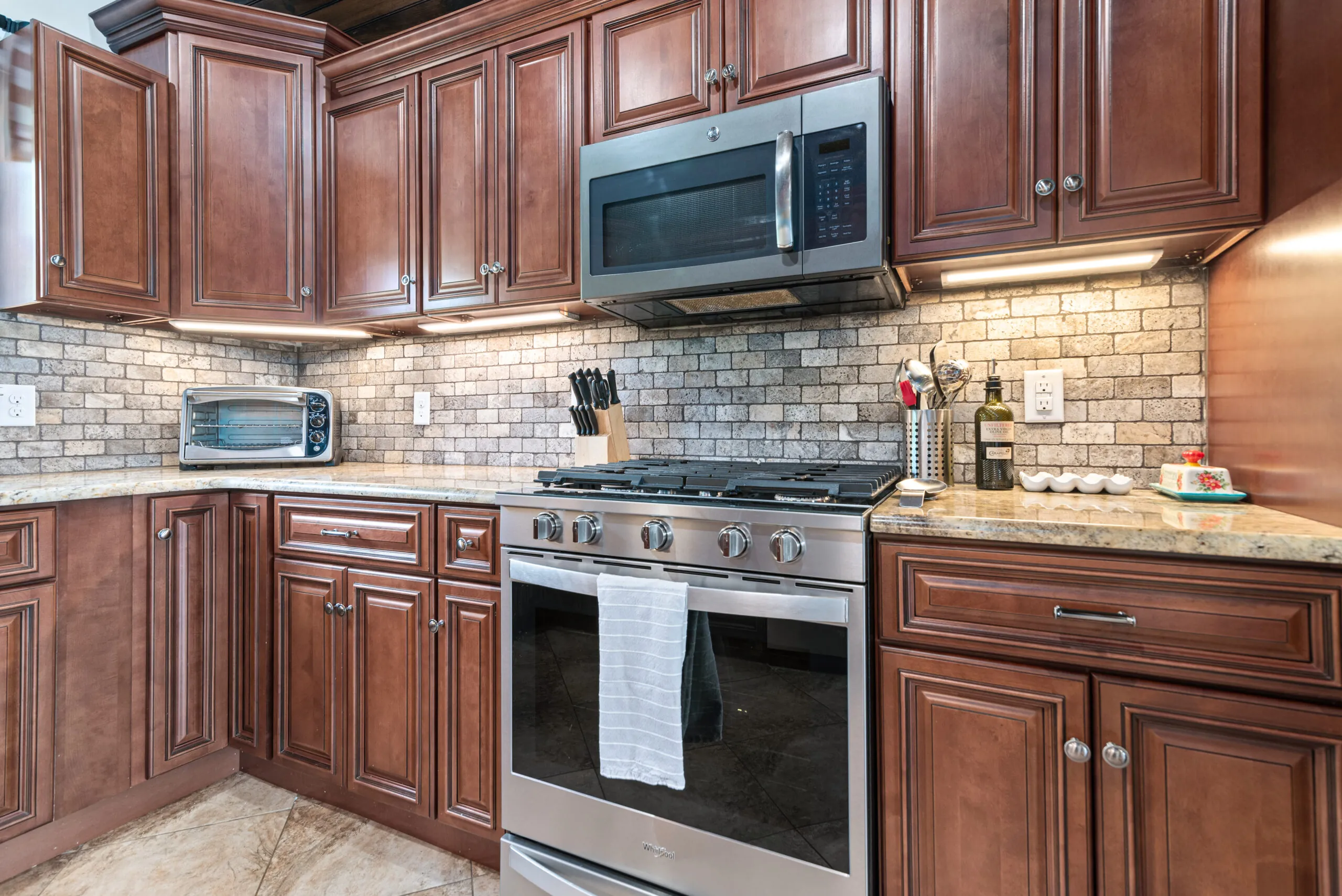 Gas range and stainless microwave in the Lowry Home kitchen