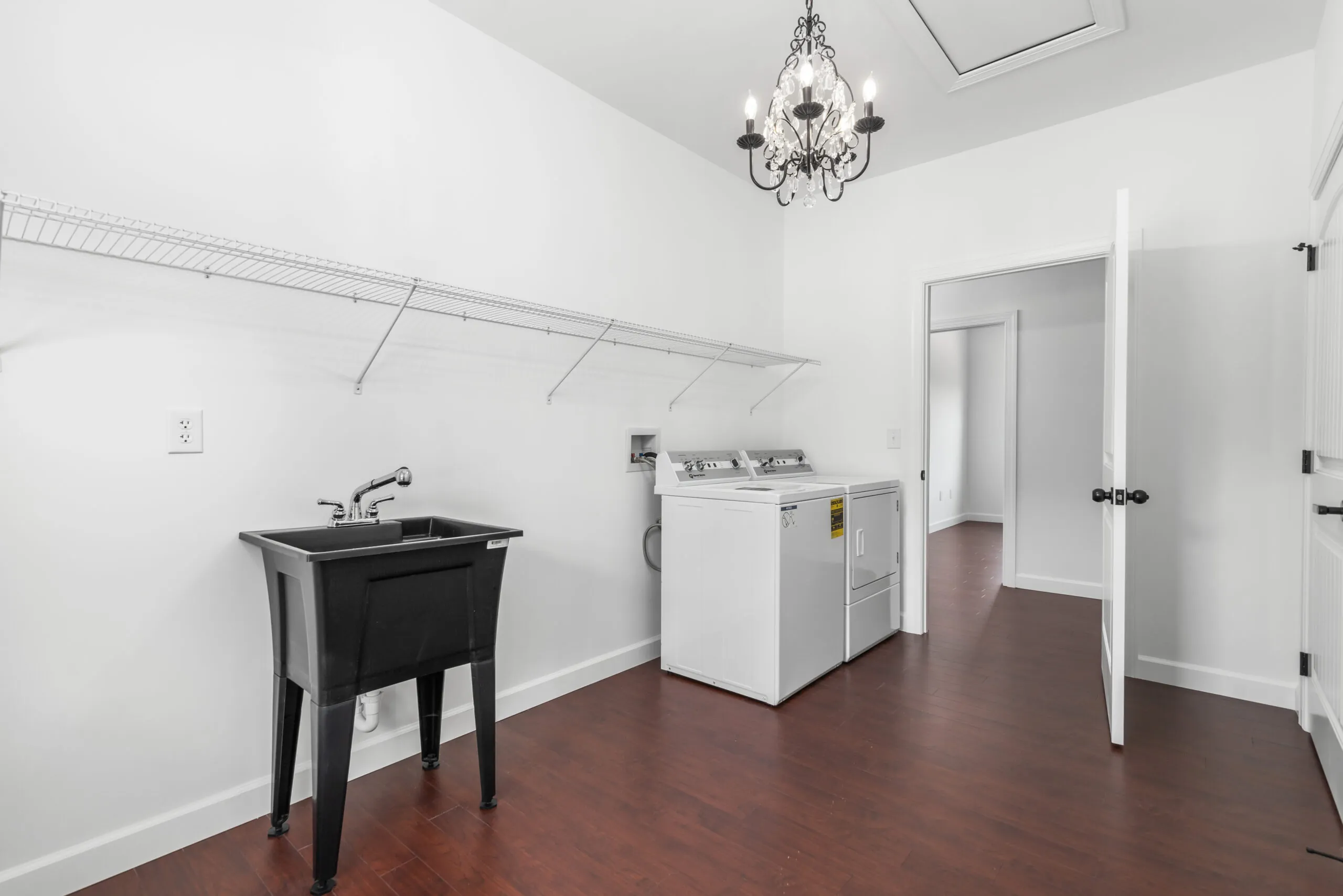 Laundry room with utility sink and washer and dryer in the Otterlea Home