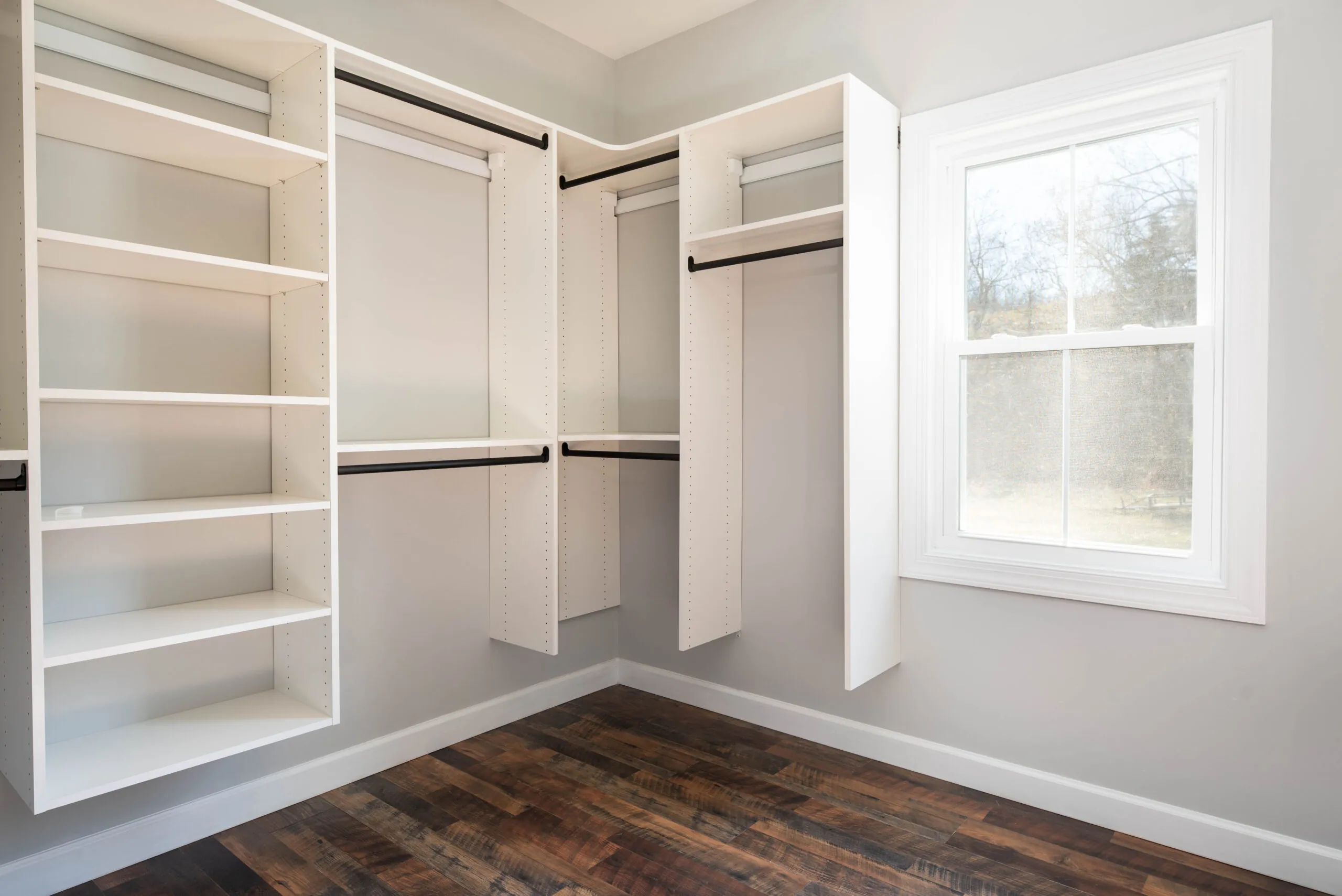 Walk-in closet with white built-in shelving in the Peters Creek Home