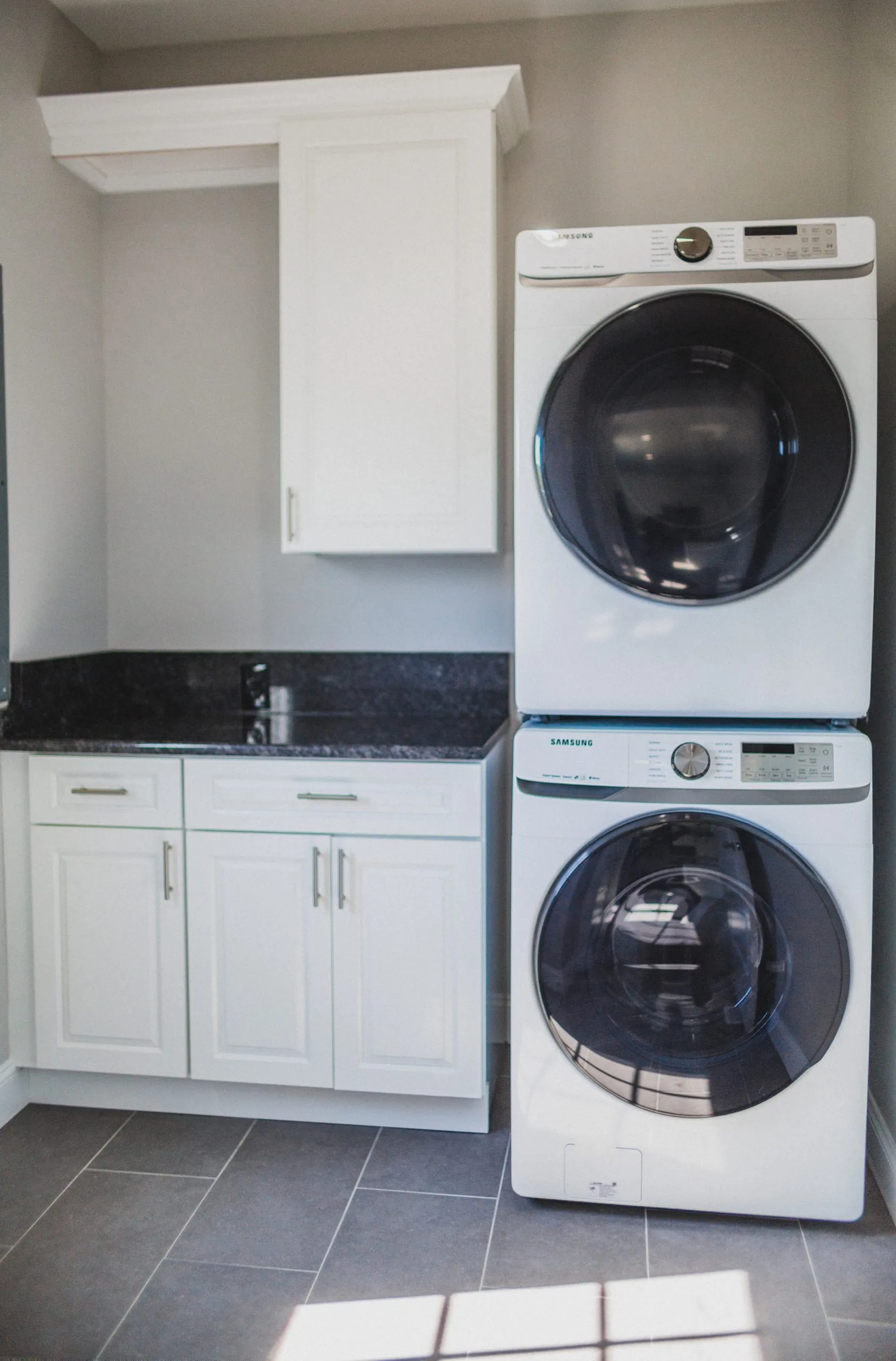 Stacked washer and dryer in the laundry room of the Falling Creek Home