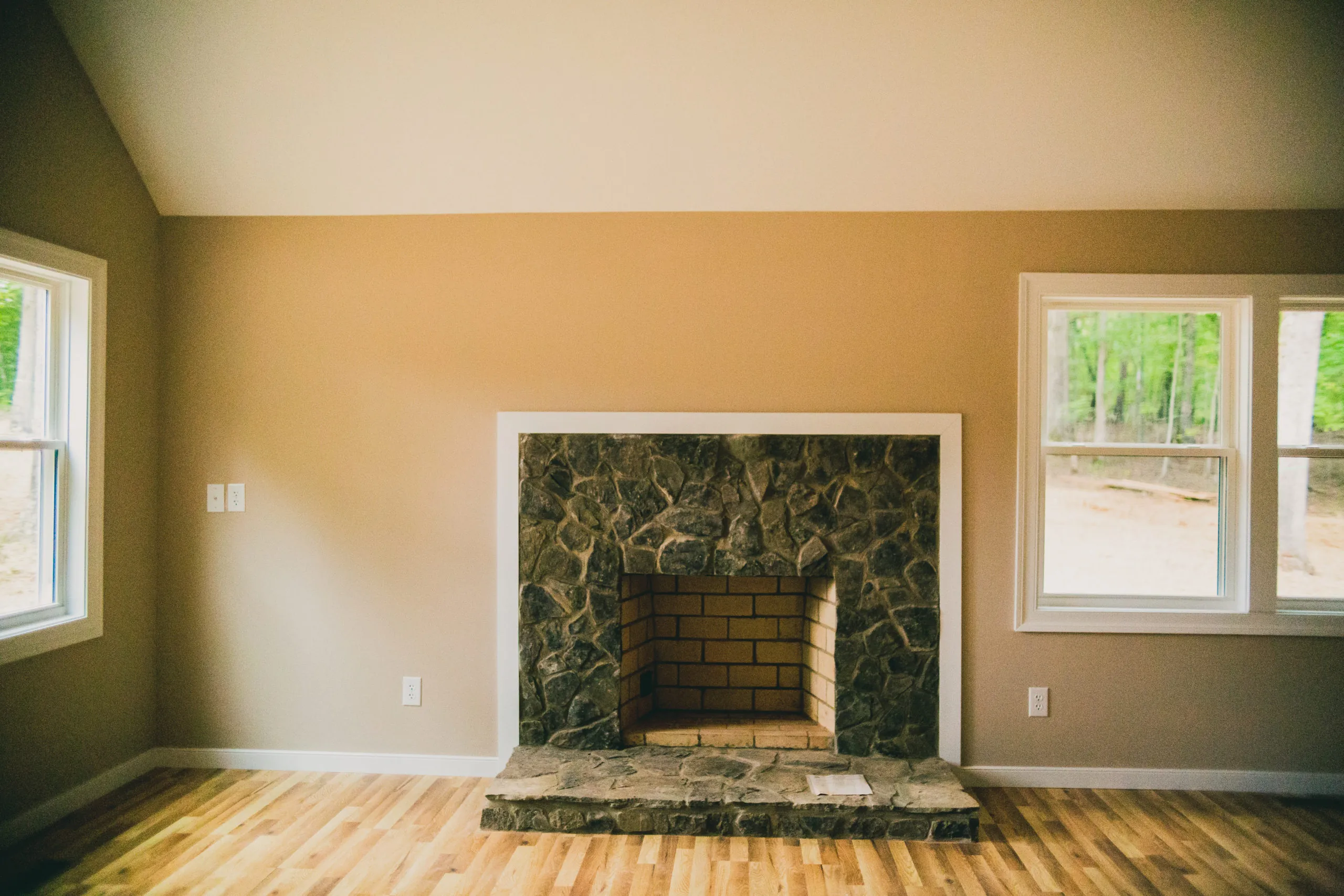 Stone fireplace with brick firebox in the Forest Home living room