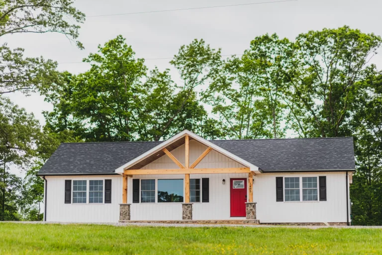 Front of the Lake Cross Home, a white board-and-batten ranch with timber gable accents.
