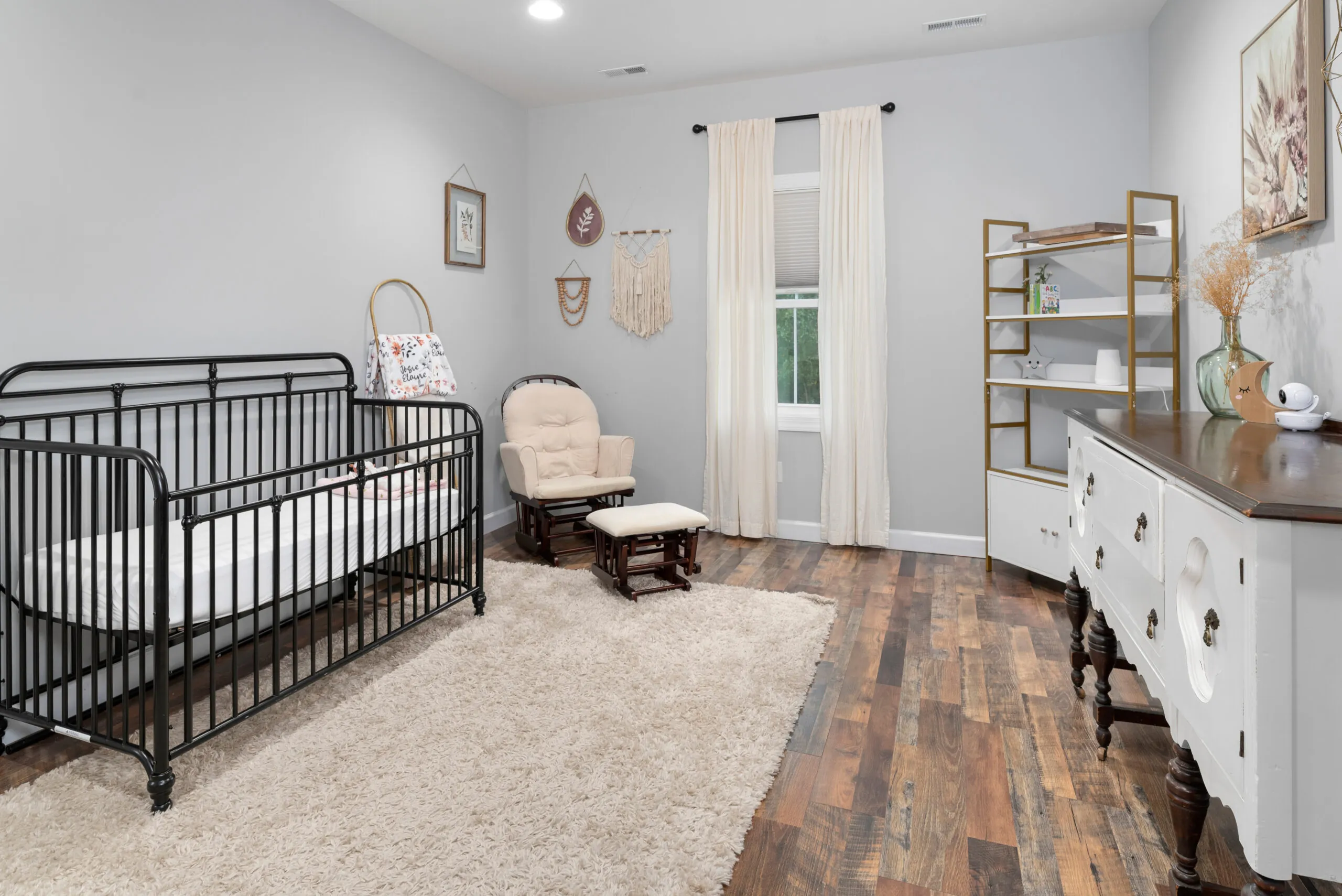 Nursery with black crib and glider in the Peters Creek Home