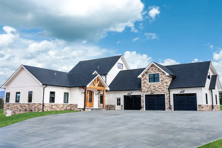 Front exterior of the Magnolia Home with stone accents, timber entry and three-car garage