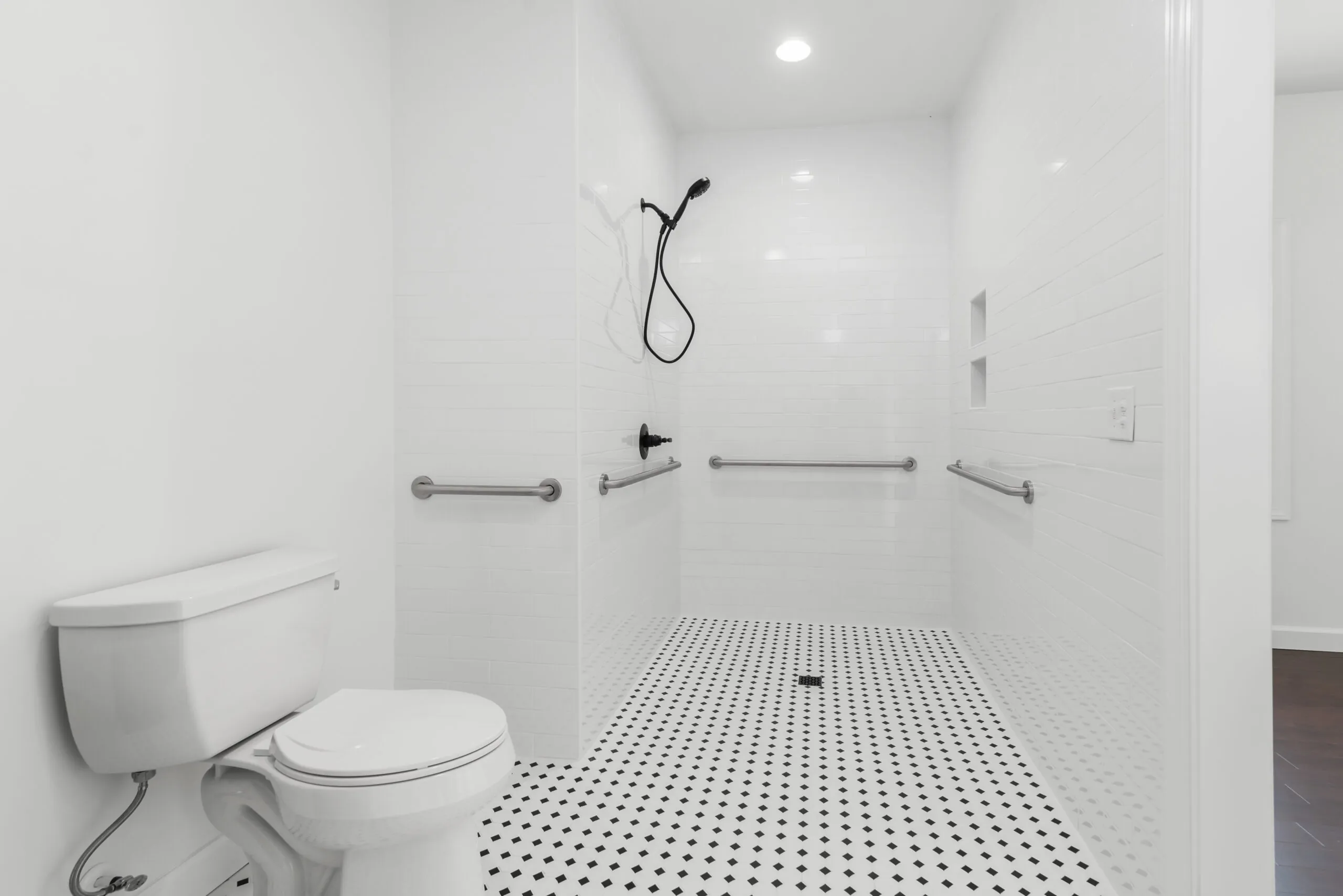 Accessible roll-in shower with grab bars in the Otterlea Home