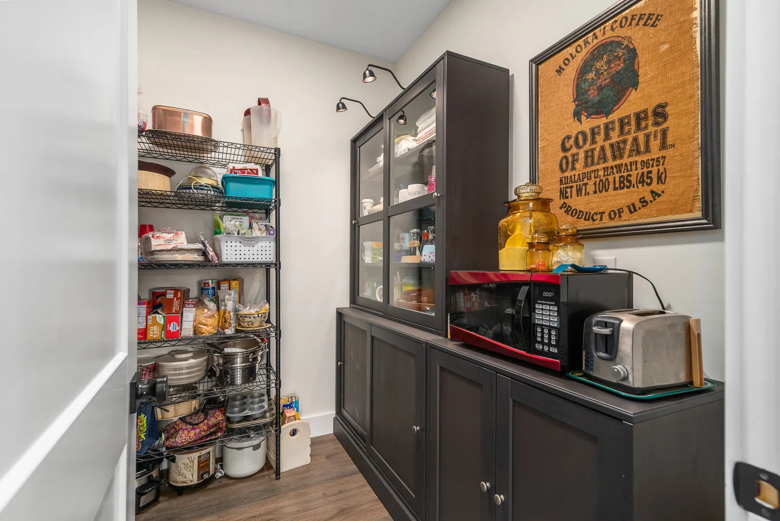 Walk-in pantry with shelving and cabinets in the LynBrook Home