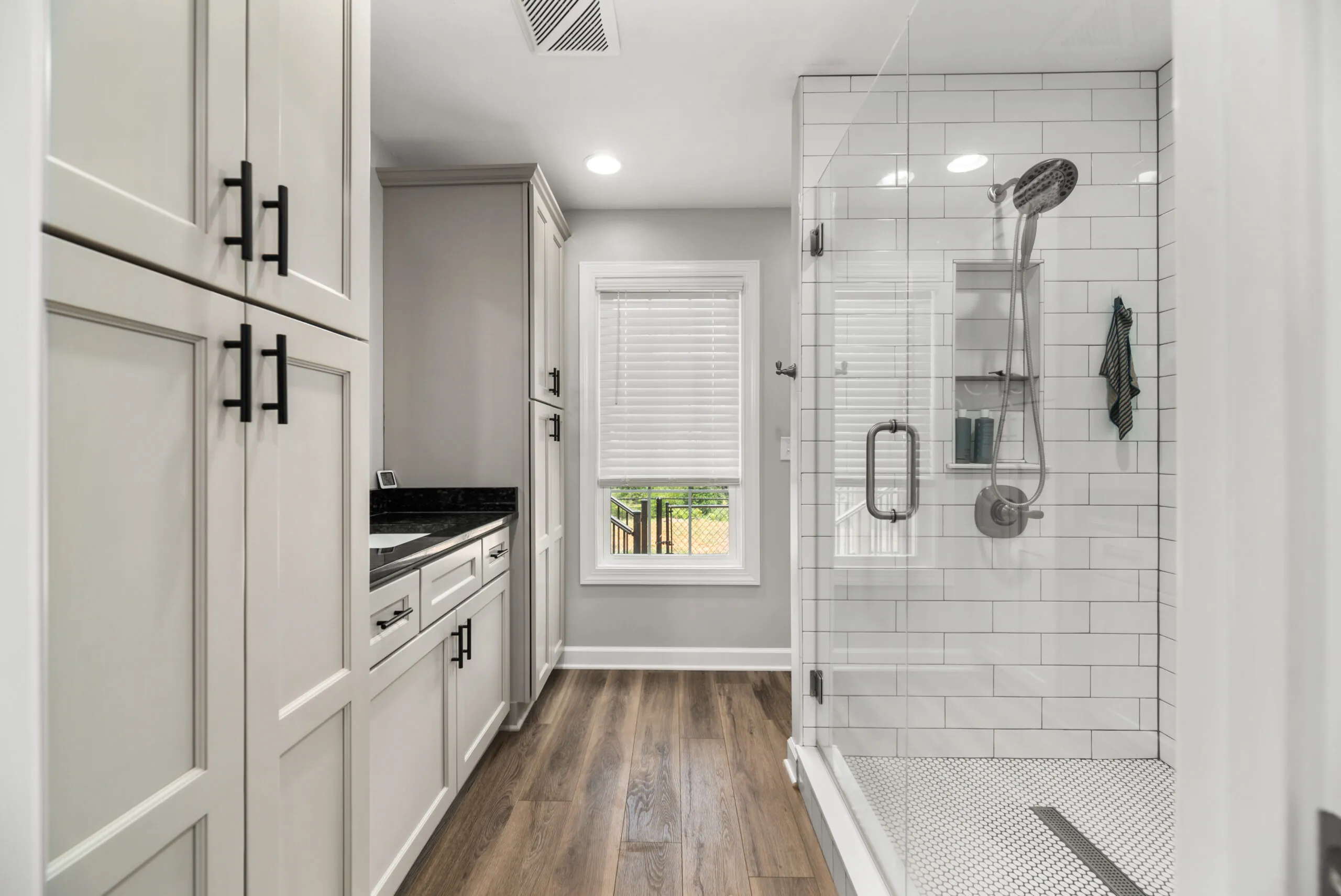 Primary bathroom with tall cabinets and tiled shower in the Timber Ridge Home