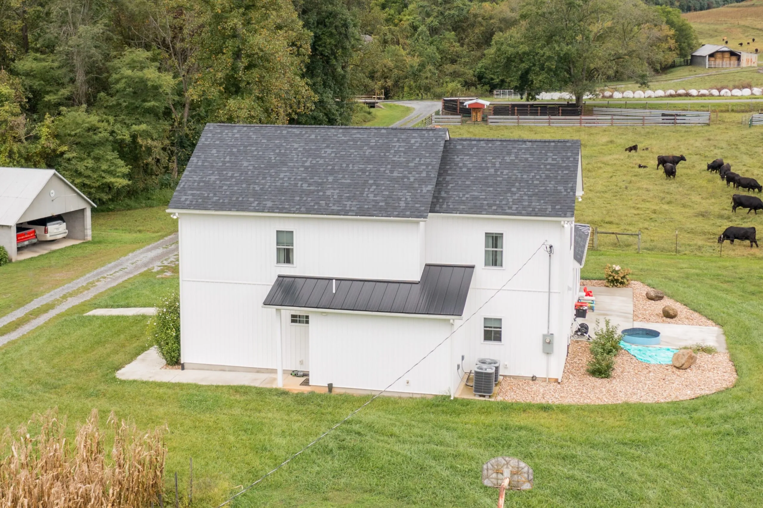 Aerial view of the Peters Creek Home rear with cattle pasture beyond