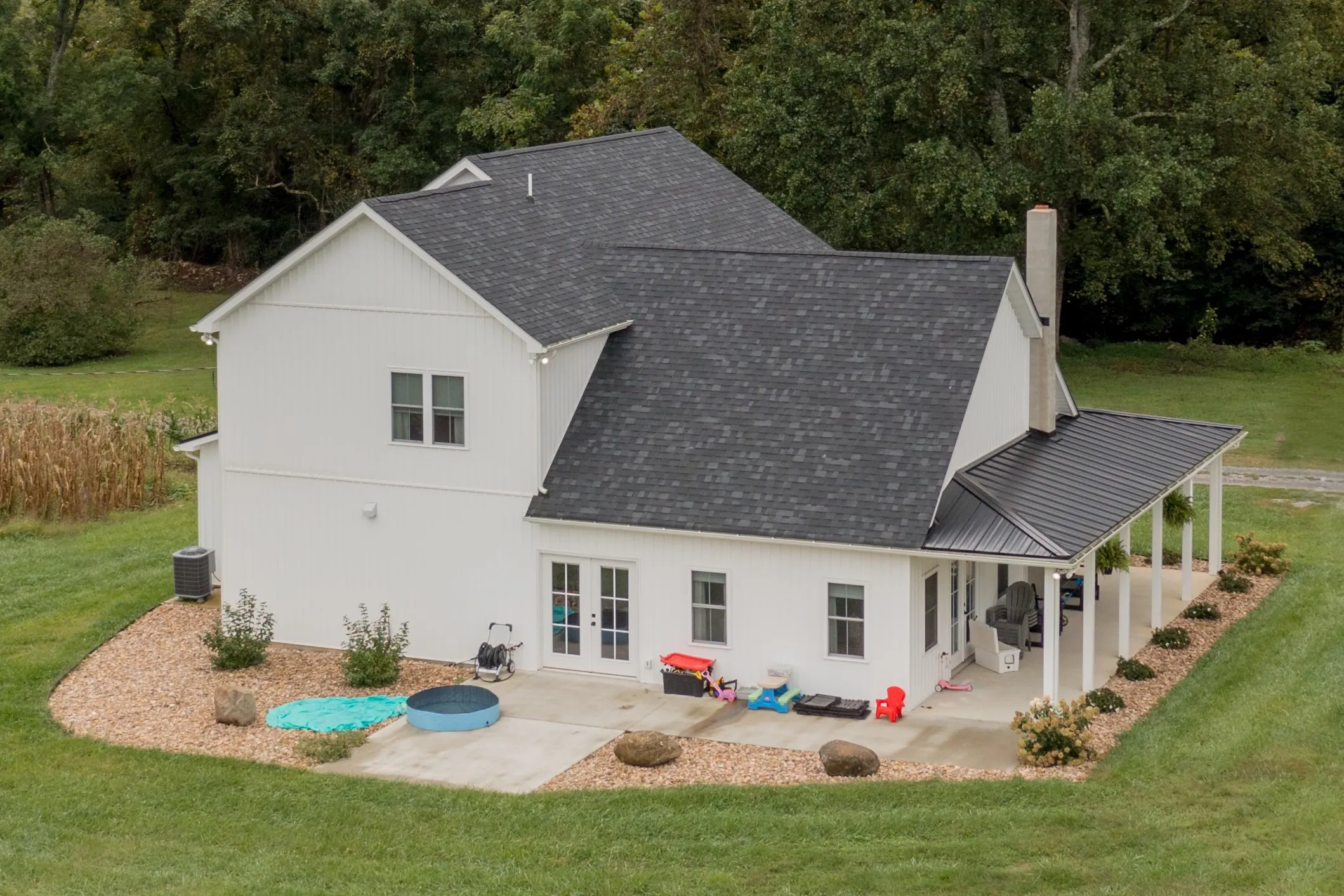 Aerial view of the Peters Creek Home rear patio and covered porch