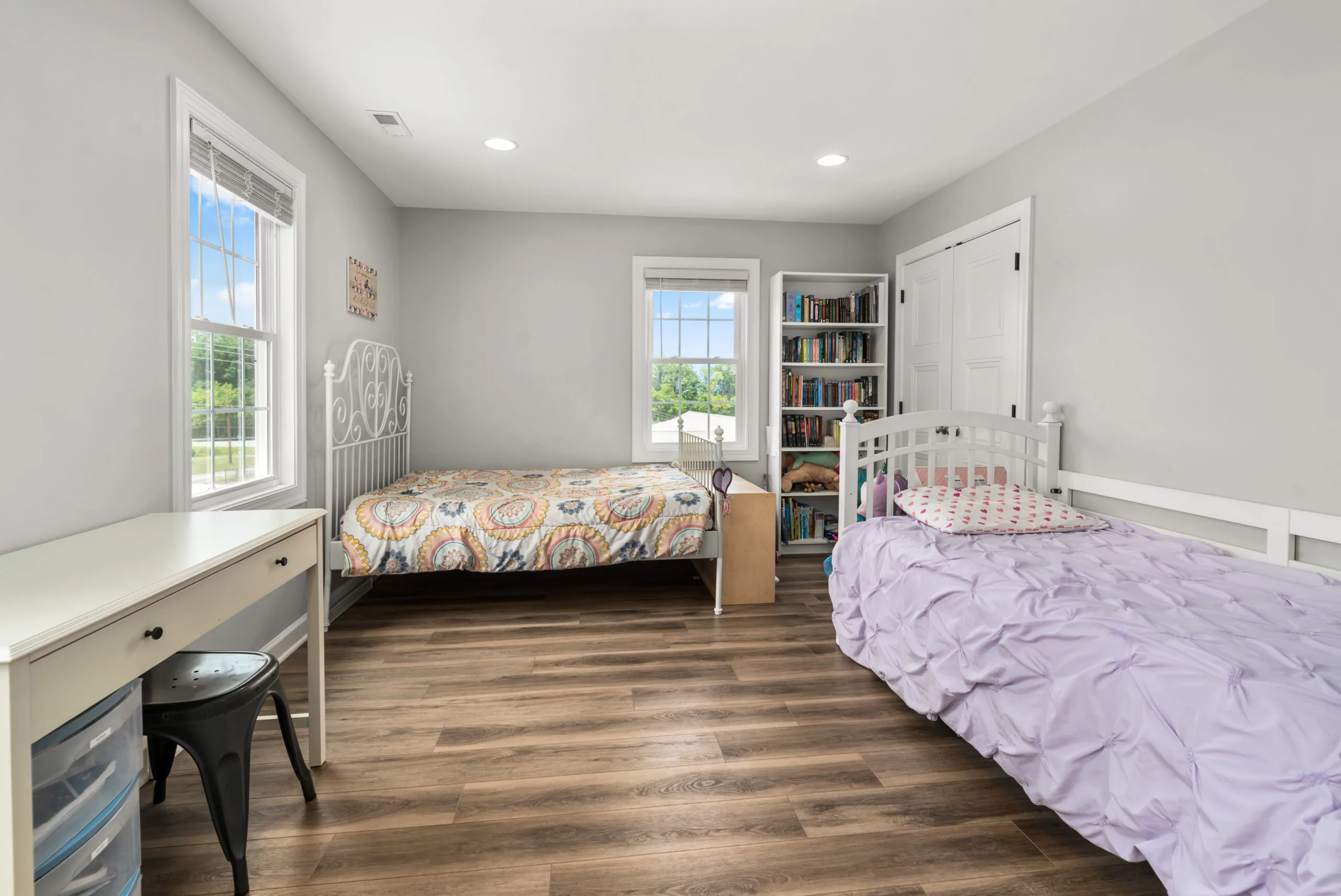 Bedroom with two twin beds, desk and bookshelf in the Timber Ridge Home