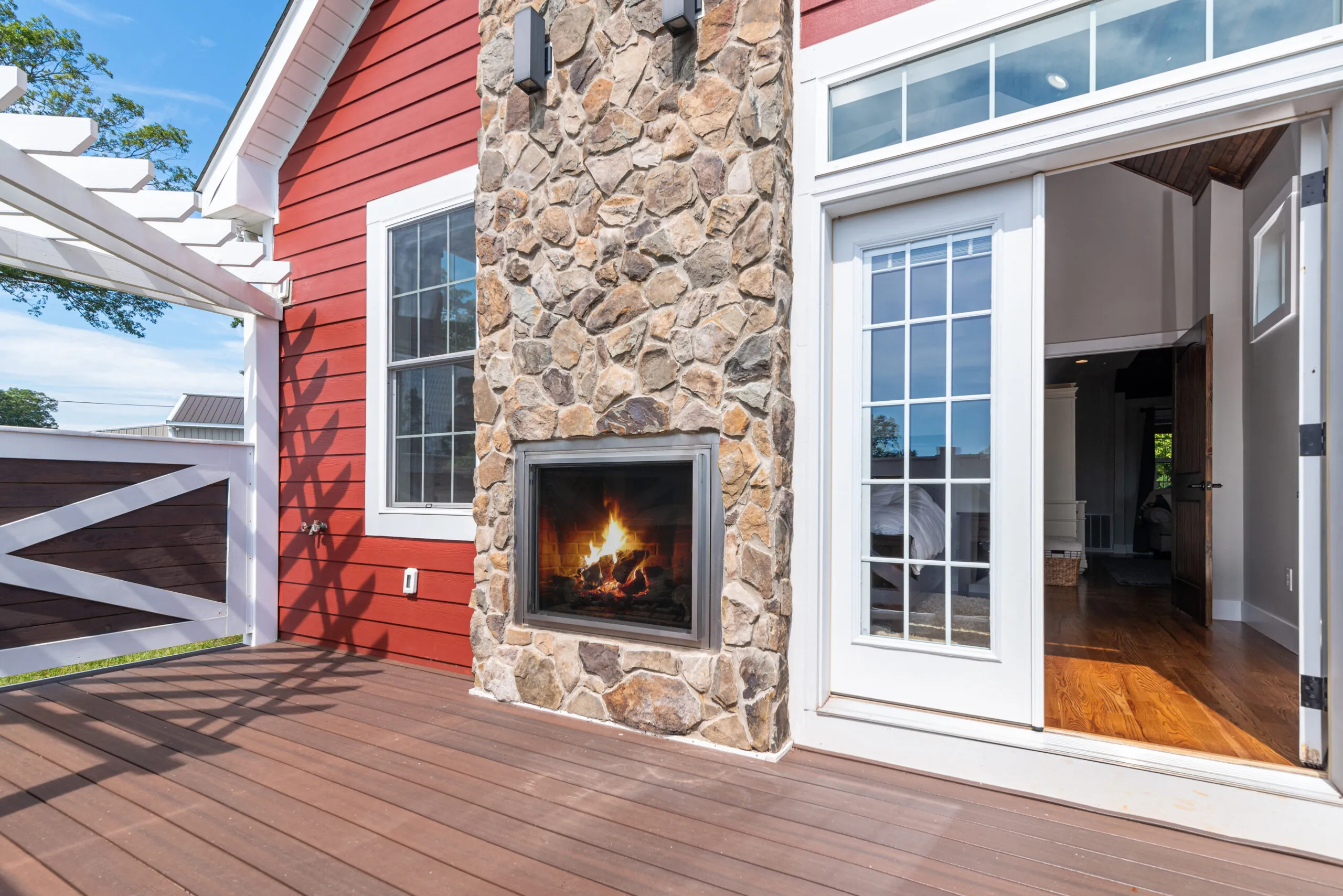 Outdoor stone fireplace on the deck of the Lowry Home