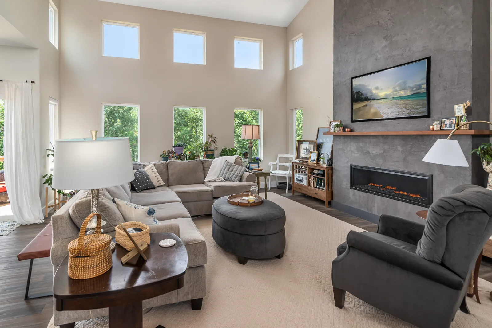 Great room with two-story windows and fireplace wall in the LynBrook Home