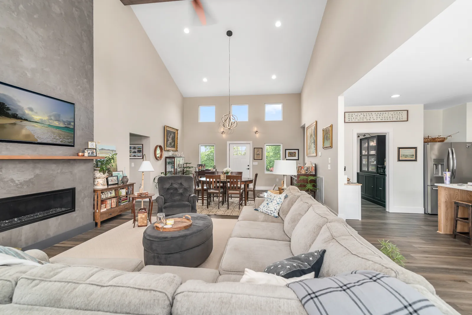 Living room with linear fireplace and tall windows in the LynBrook Home