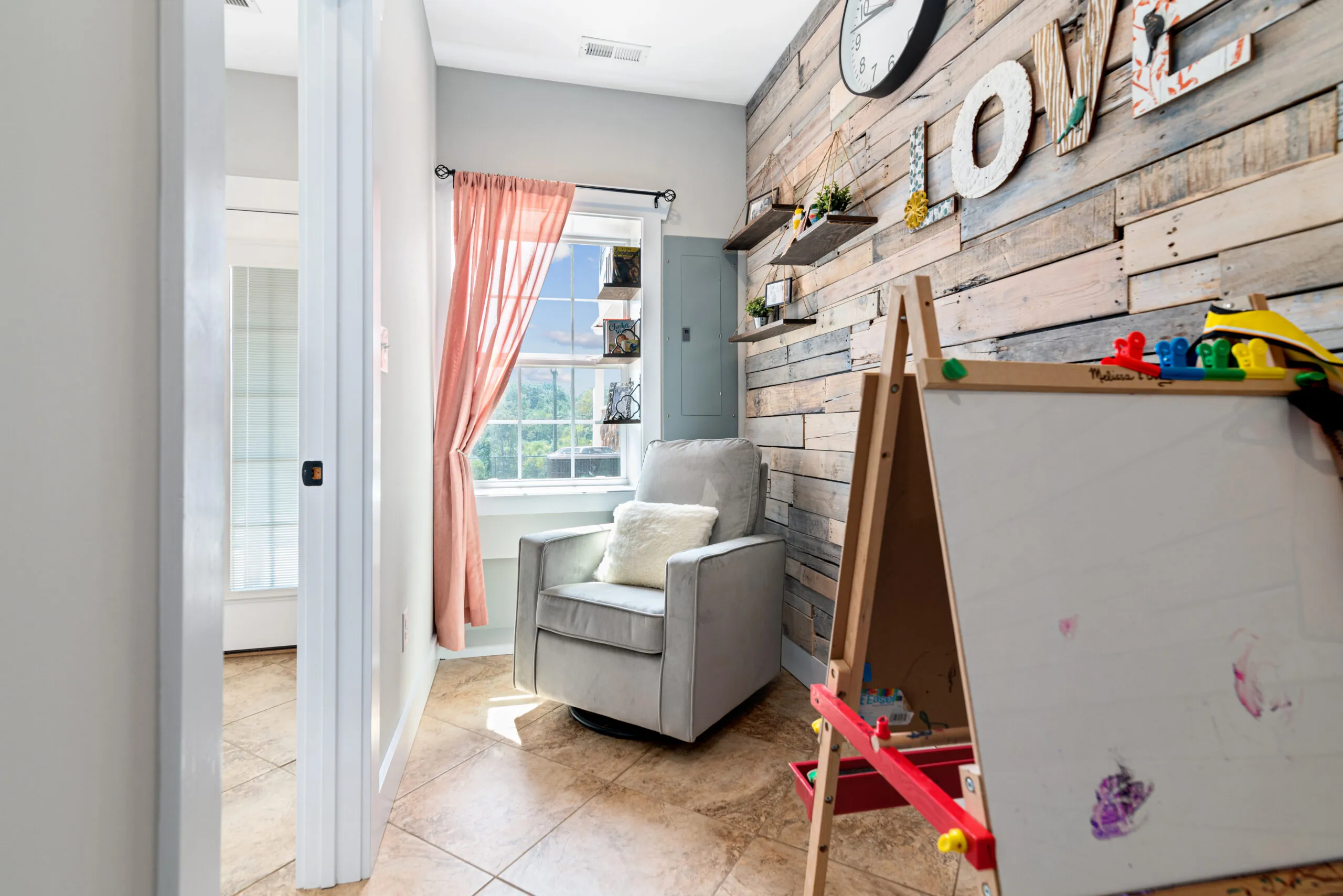 Reading nook with glider and shiplap accent wall in the Lowry Home