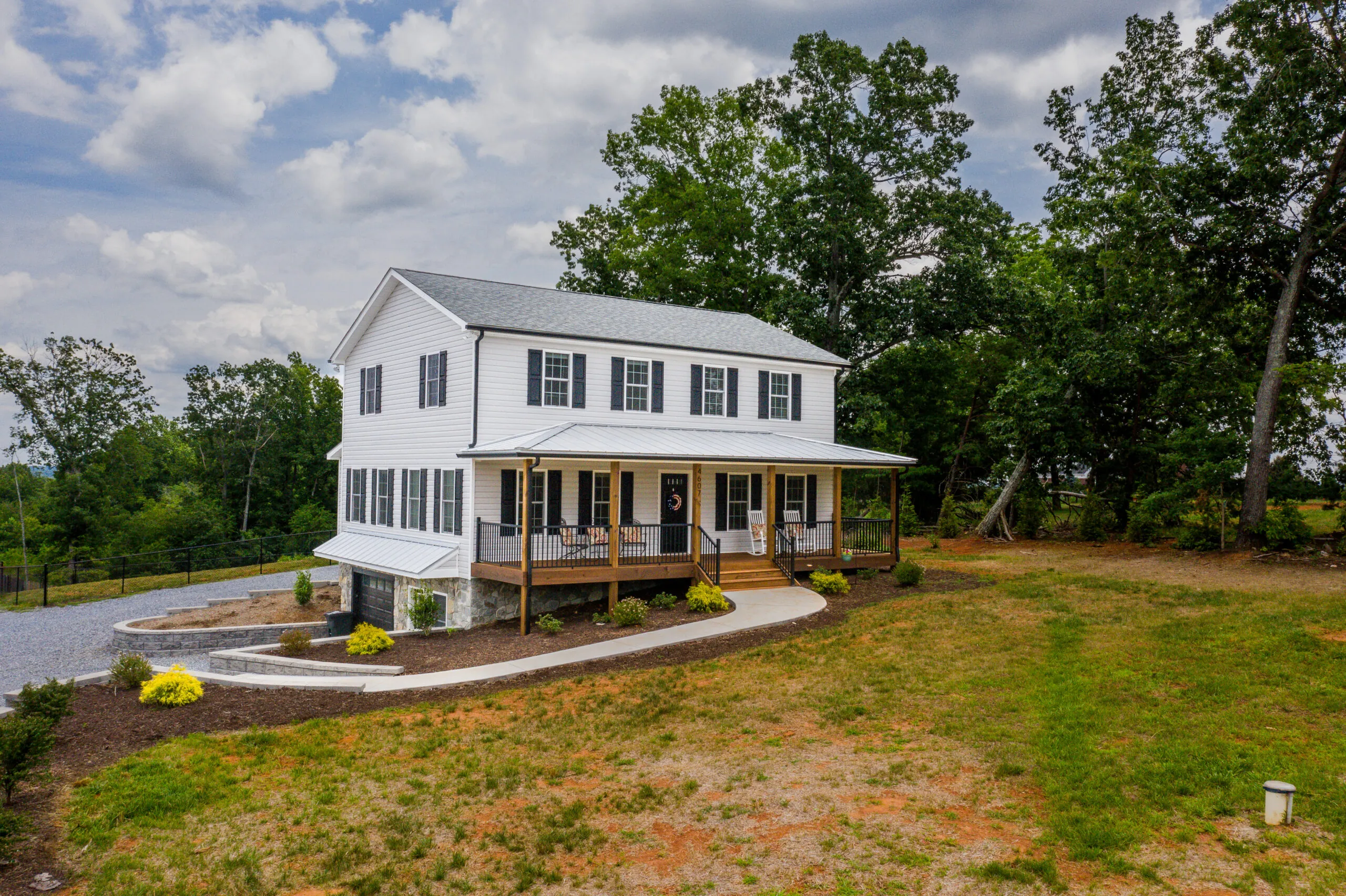 Angled front view of the Timber Ridge Home with wraparound walkway and porch