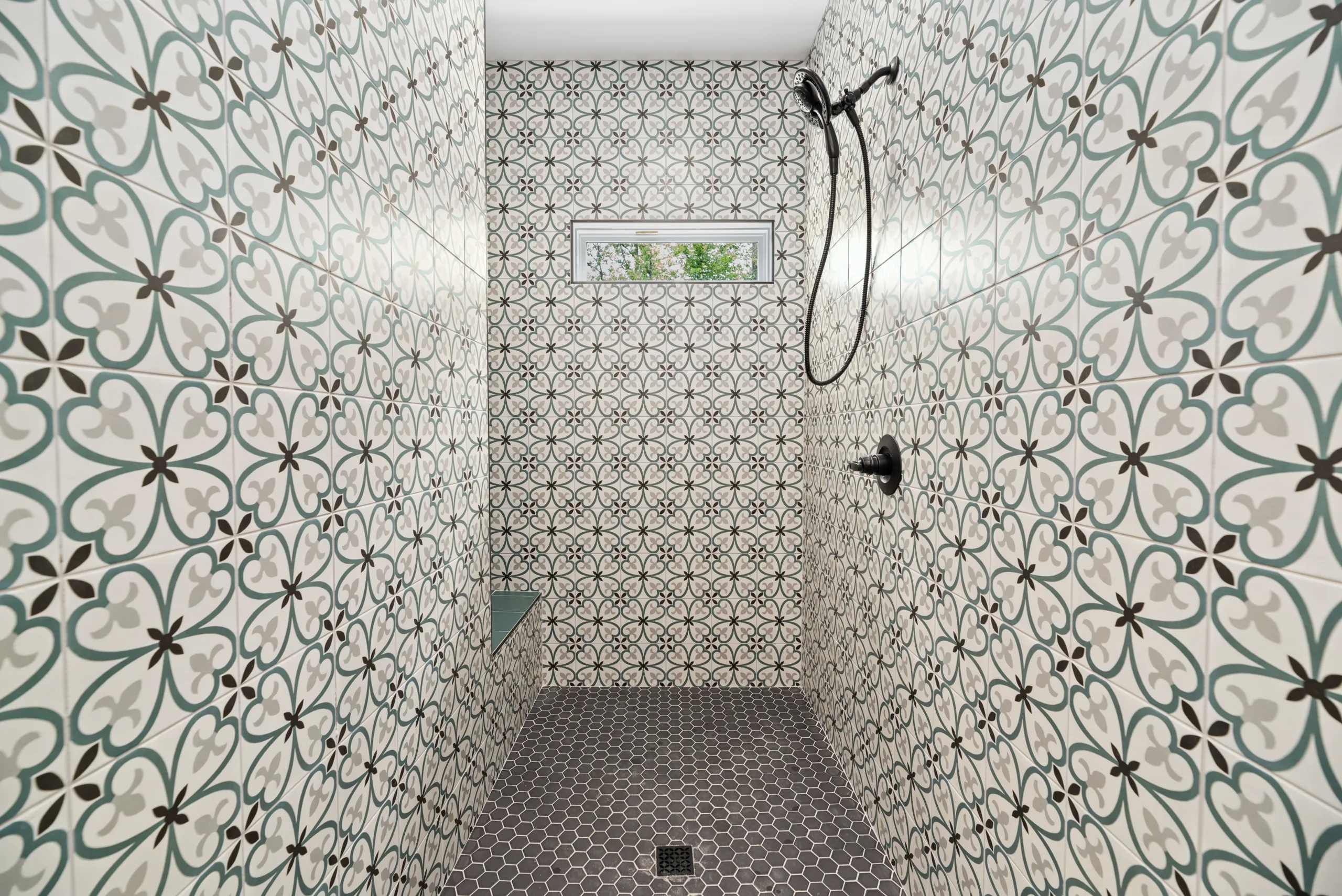 Walk-in shower with patterned tile in the Lake Crest Home
