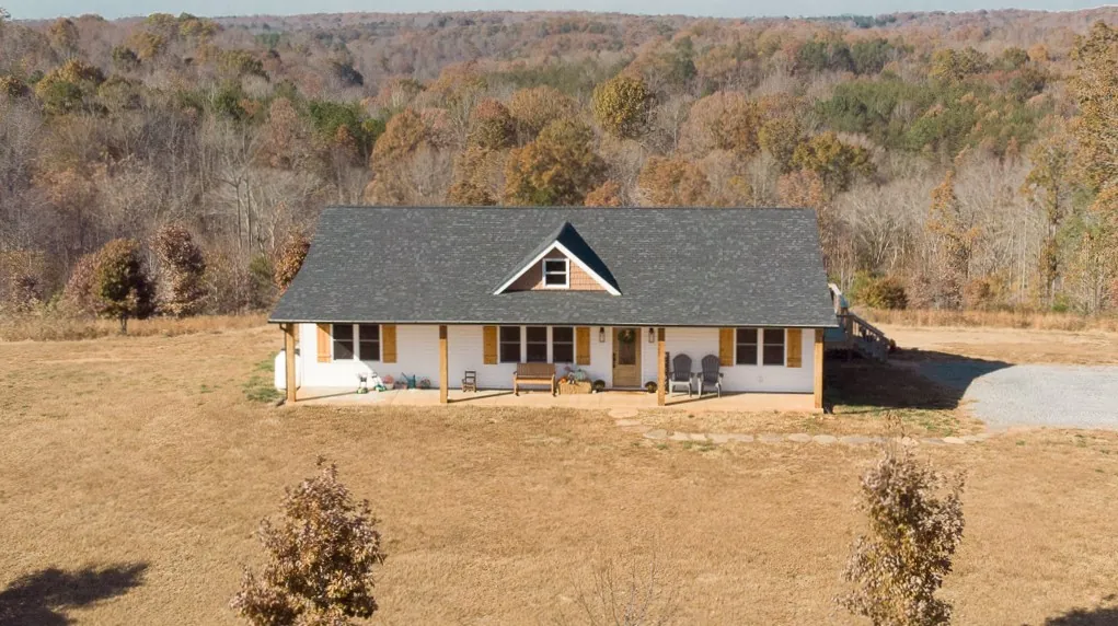 Aerial view of the Carter's Mill Home on its wooded hillside lot