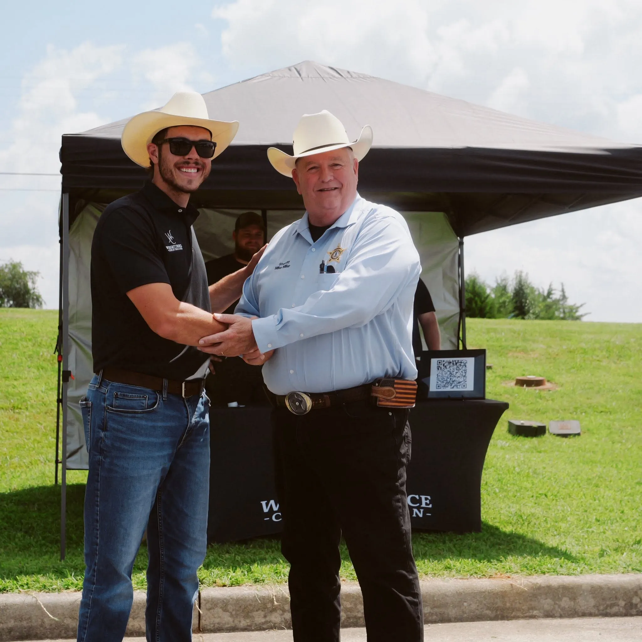 Wright Choice crew member shaking hands with a sheriff at a community event