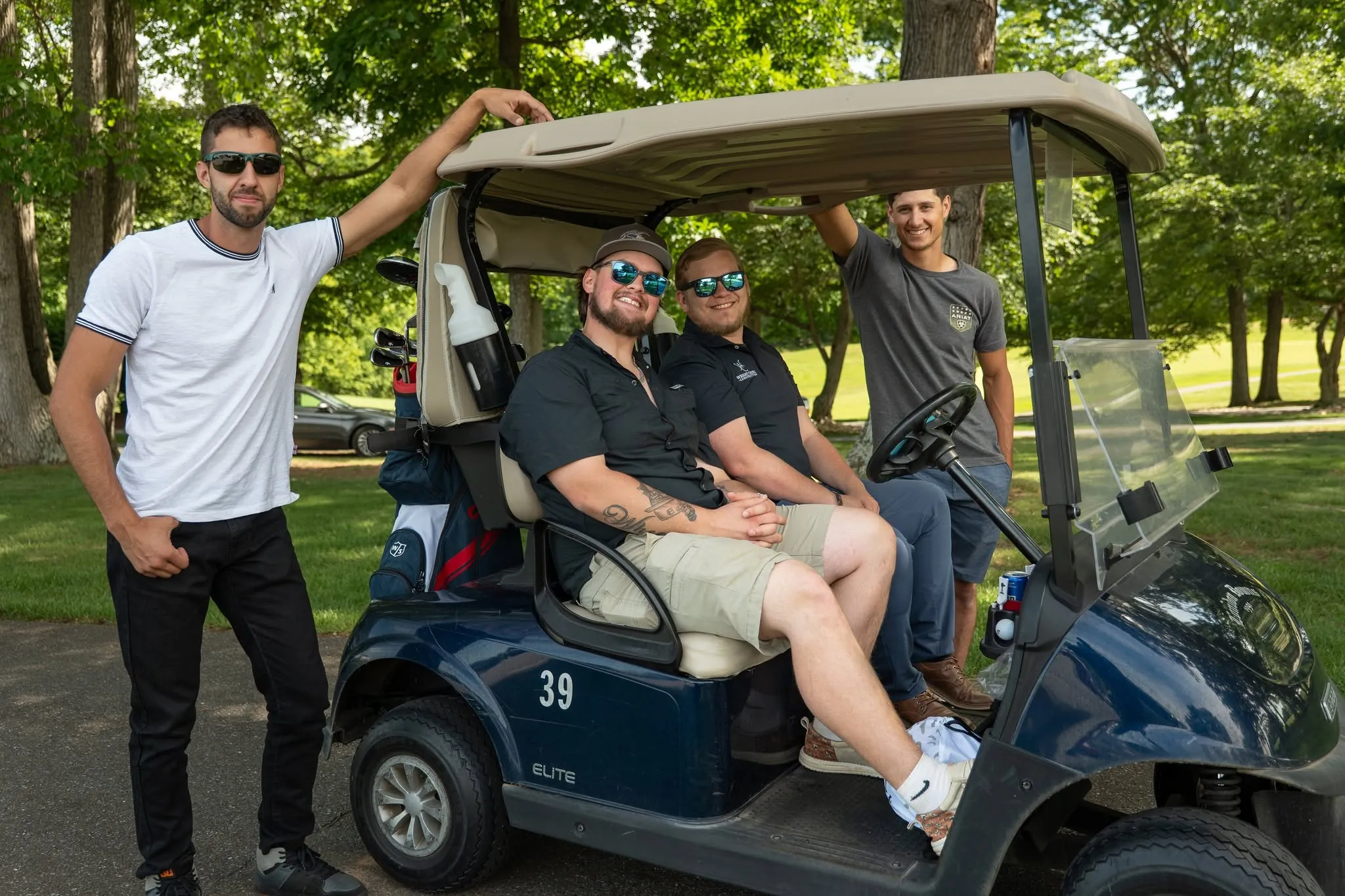Four people on a golf cart at a Wright Choice golf tournament