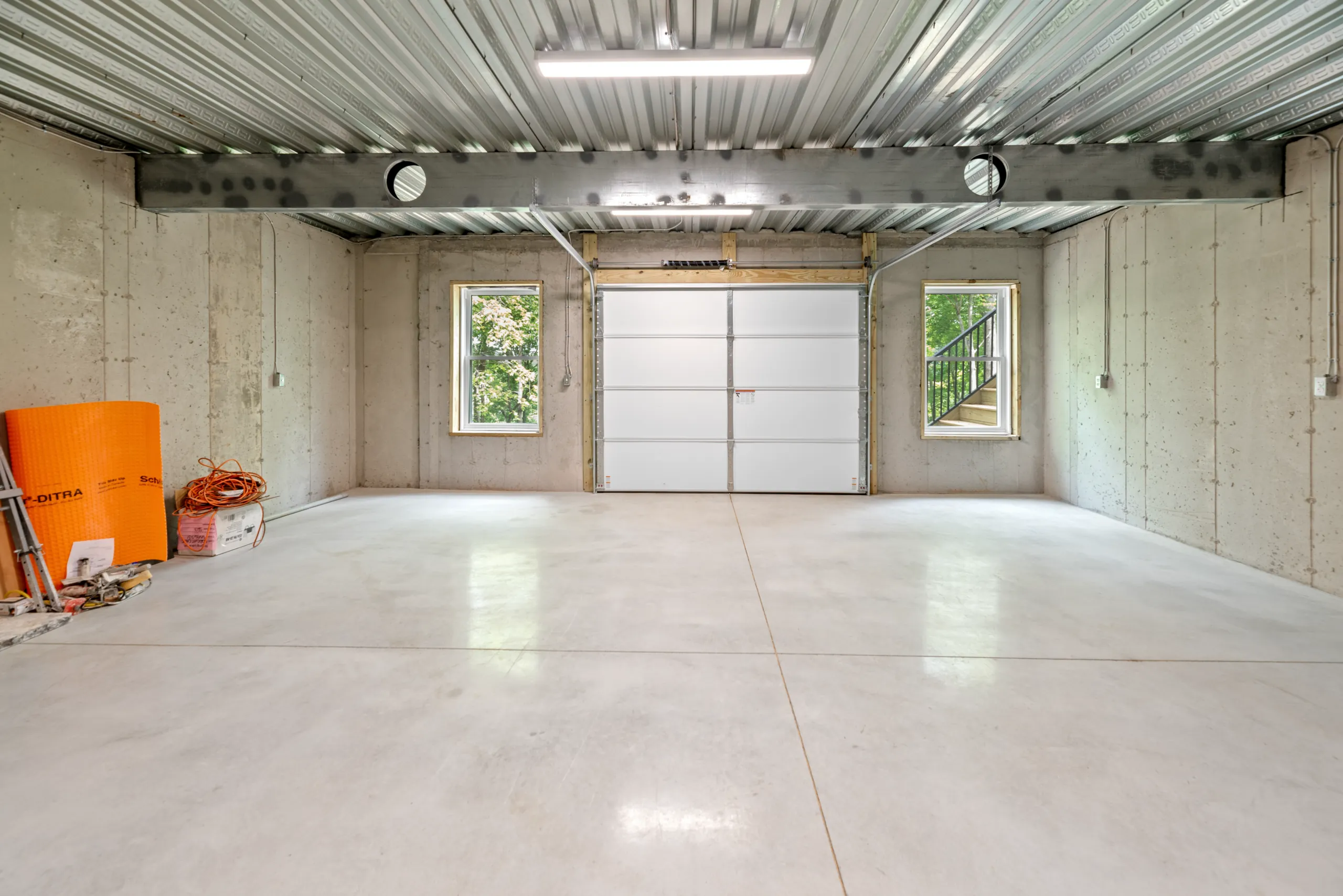 Single-bay garage with polished concrete floor in the Lake Crest Home