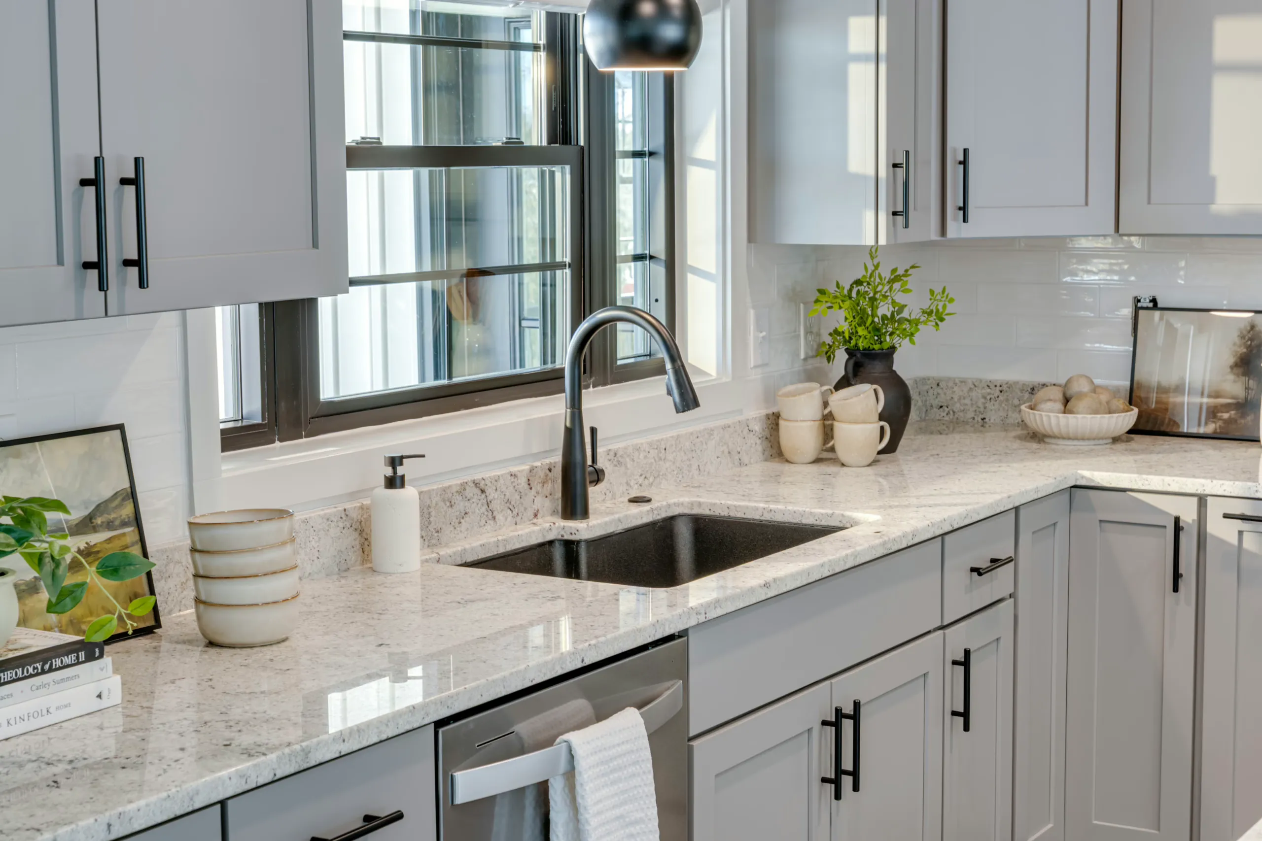 Kitchen sink with black faucet and granite counter in the Powell Lane Home
