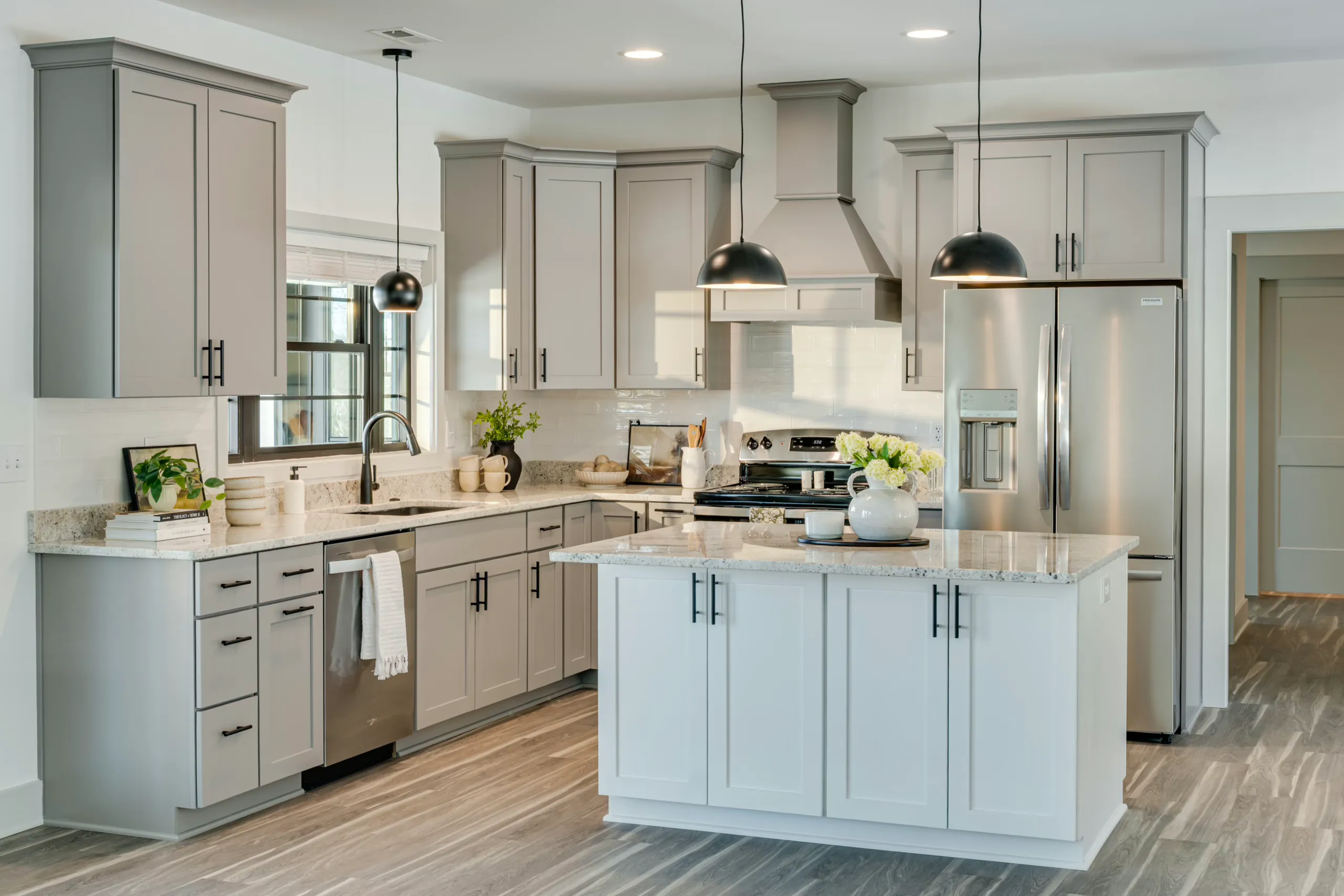 Powell Lane Home kitchen with gray cabinets, white island and stainless appliances