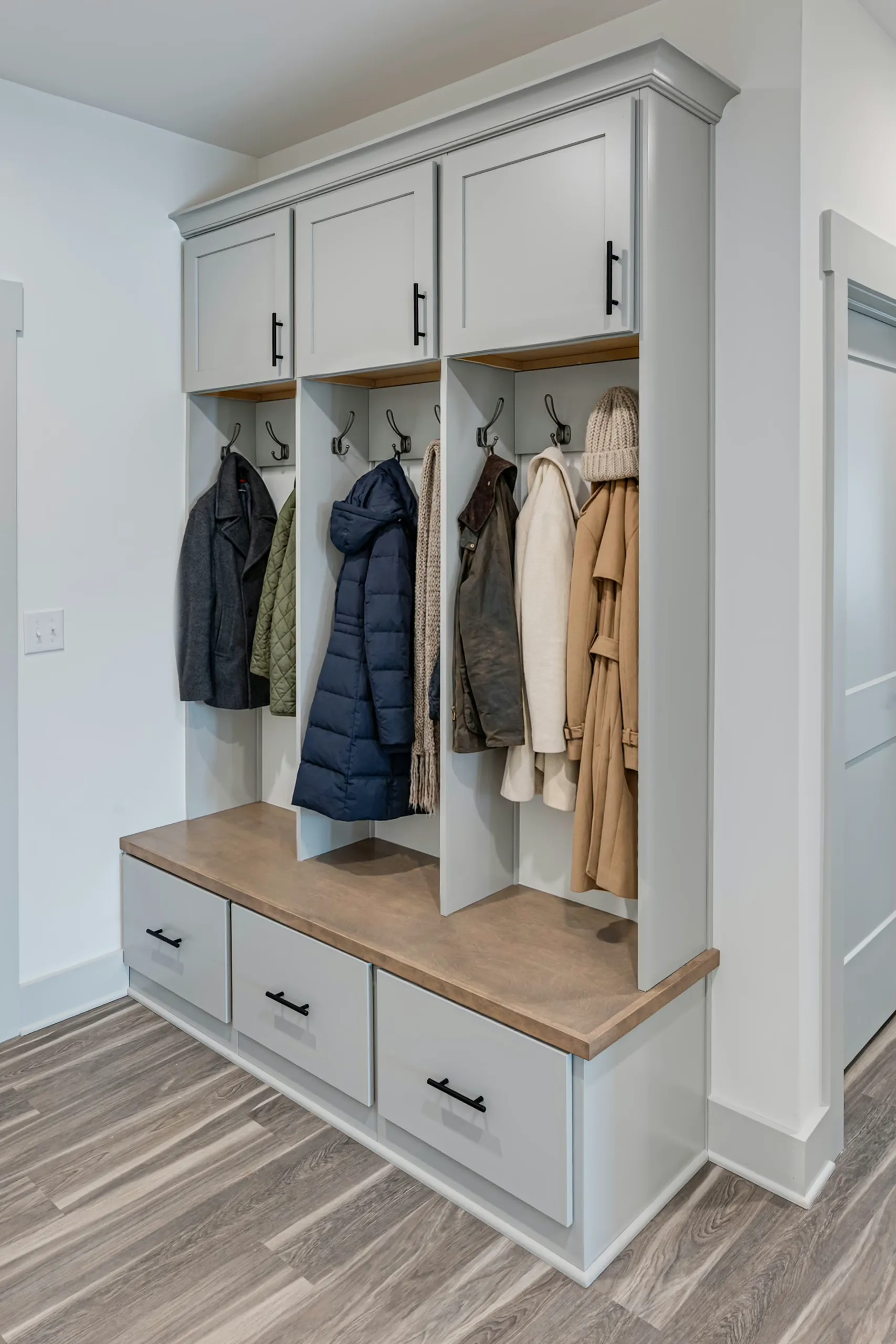Mudroom locker bench with hooks and drawers in the Powell Lane Home