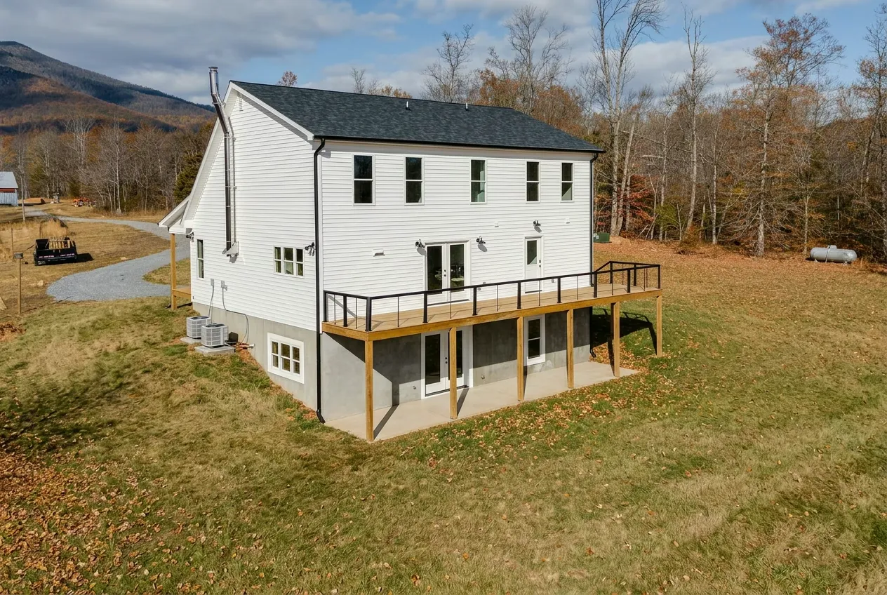 Rear aerial view of the Meaders Mill Home with deck and walkout basement