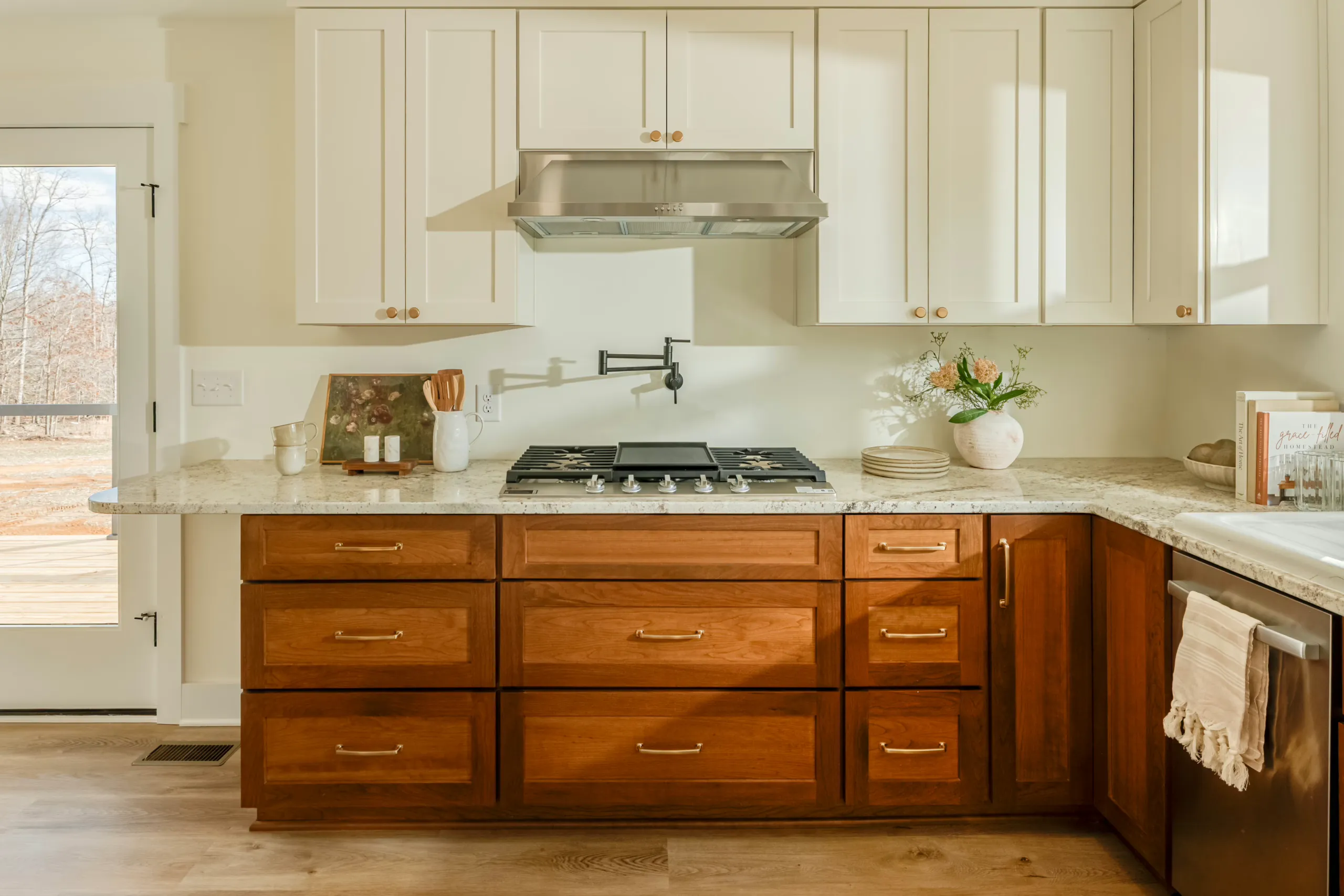 Gas cooktop, pot filler and wood lower cabinets in the Meaders Mill Home