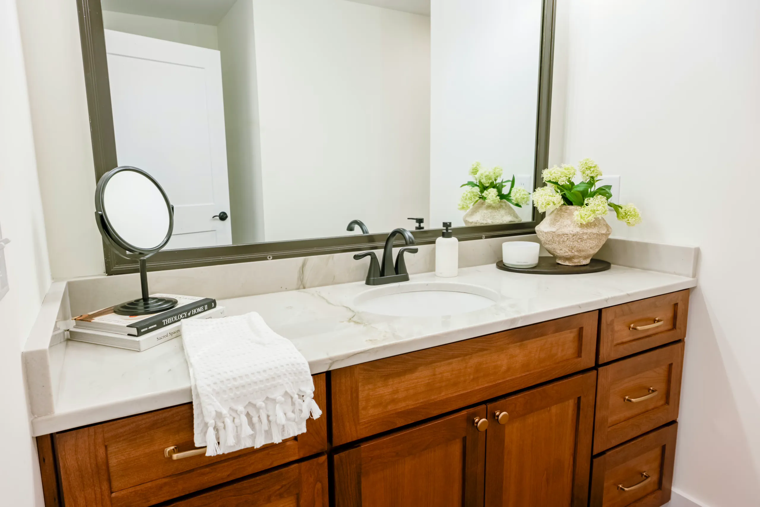 Half bath vanity with wood cabinets and quartz top in the Meaders Mill Home