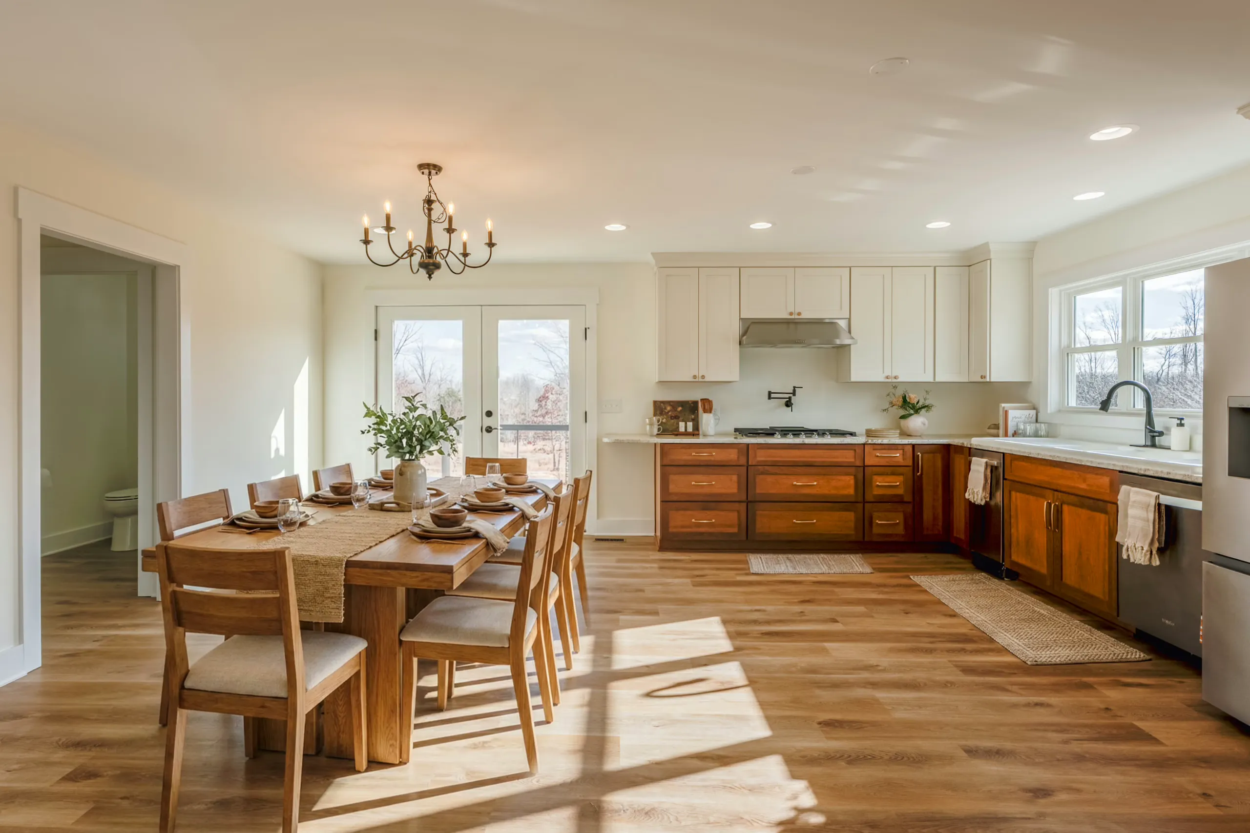 Kitchen and dining area with wood cabinets and French doors in the Meaders Mill Home