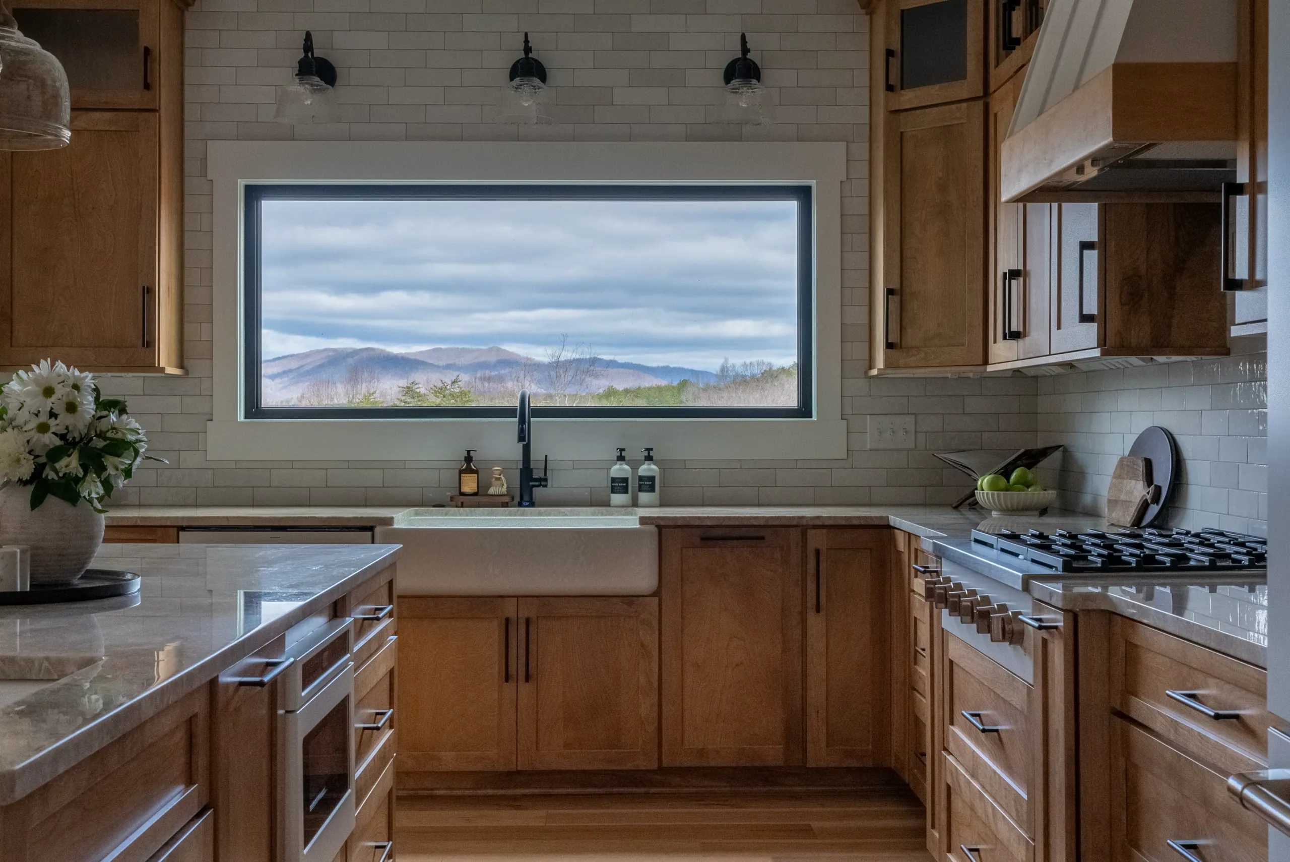 Magnolia Home kitchen with farmhouse sink under a window framing mountain views