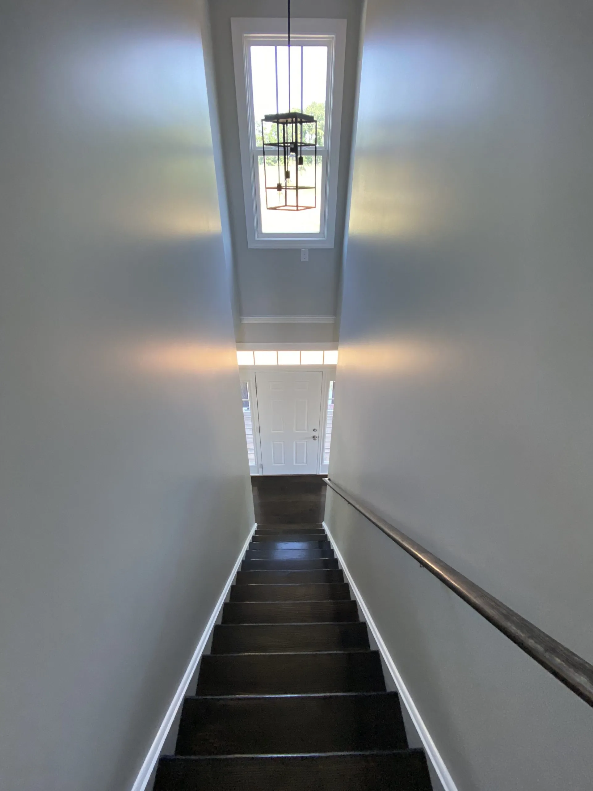 Stairway leading down to the front door in the Falling Creek Home