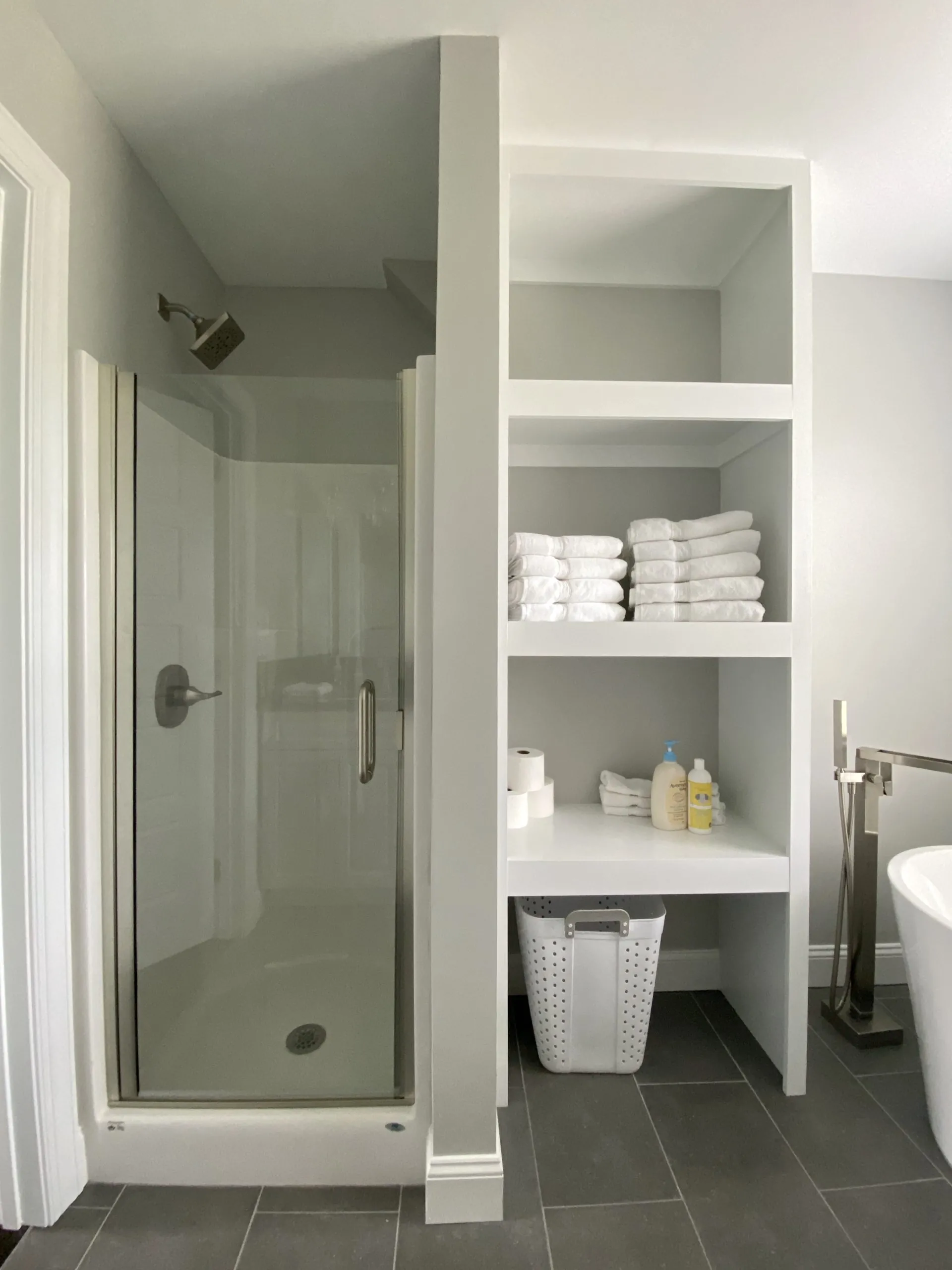 Bathroom shower and open linen shelving in the Falling Creek Home