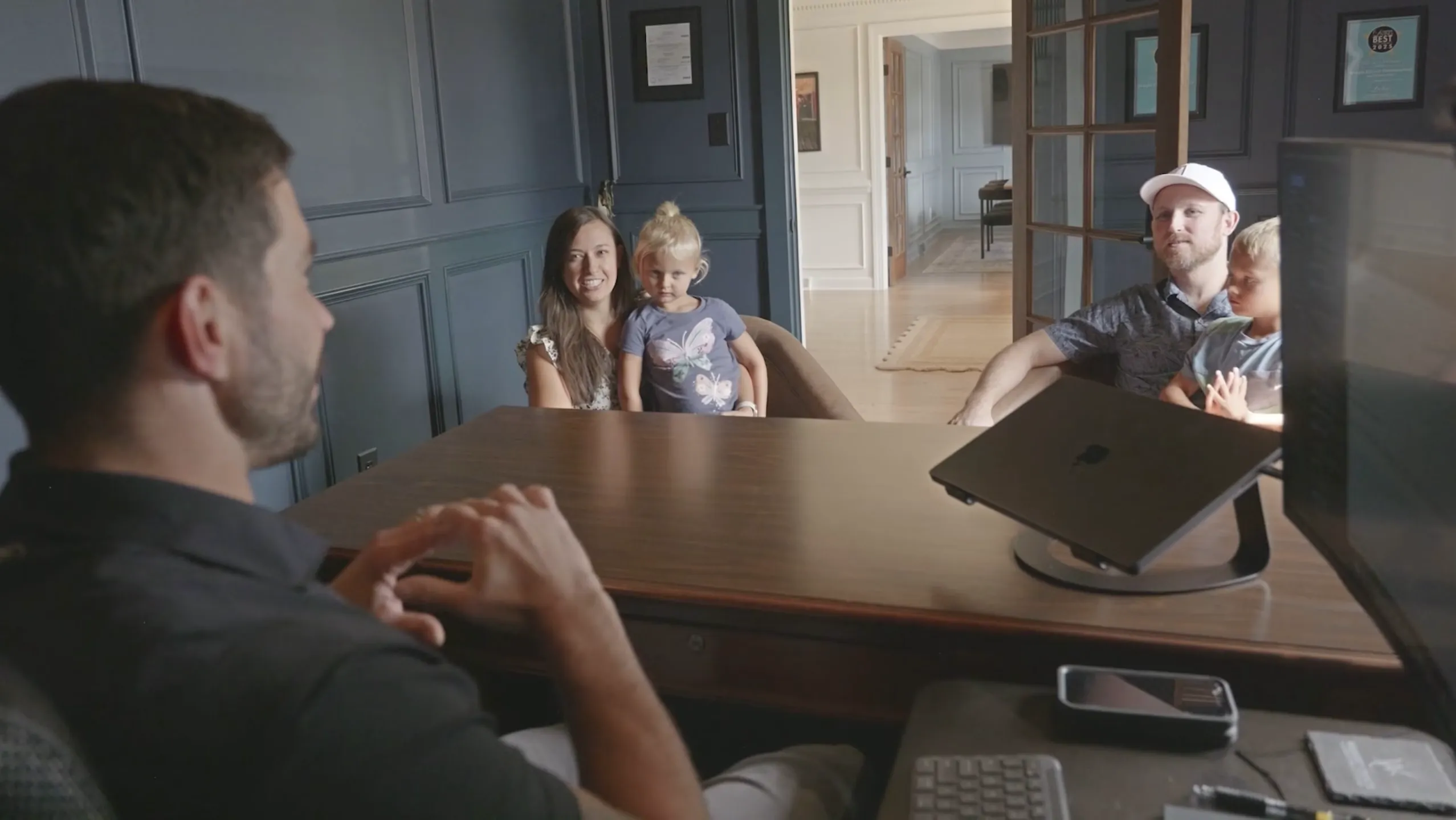 John Wright in a sales meeting with customers and their children.
