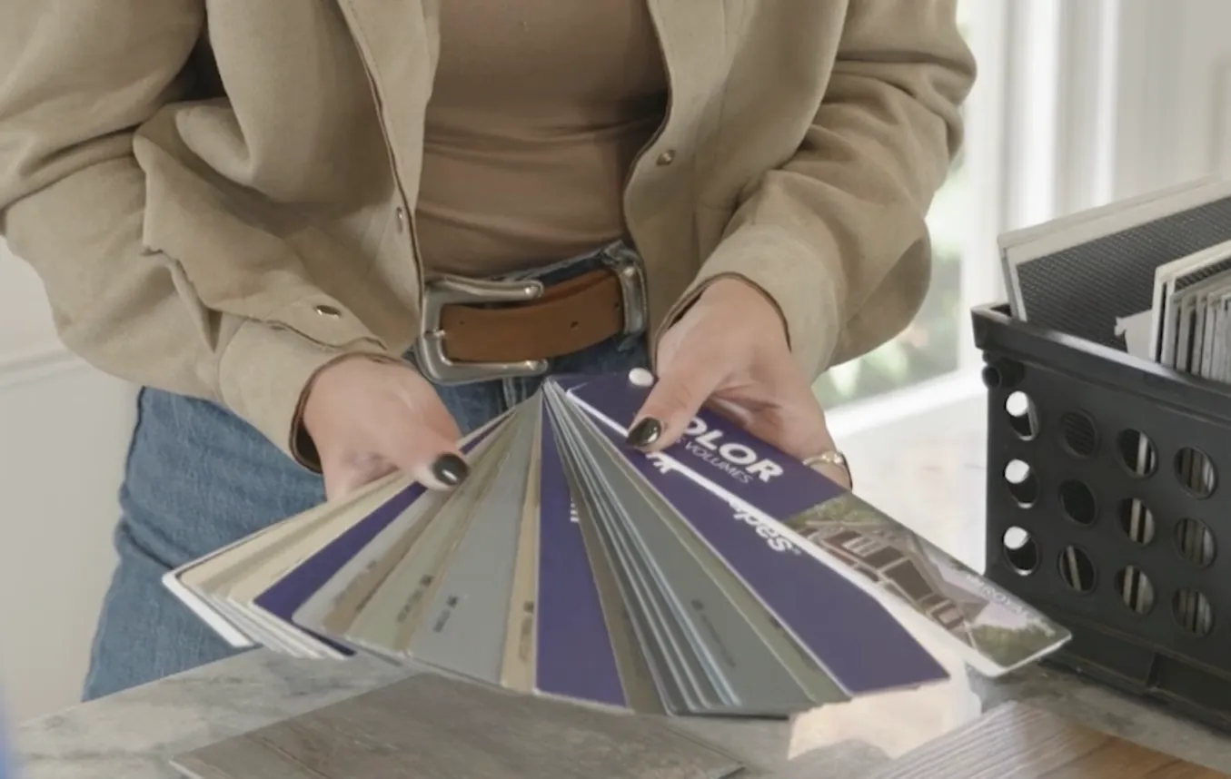 Frankie McManus fanning out various different color siding samples.