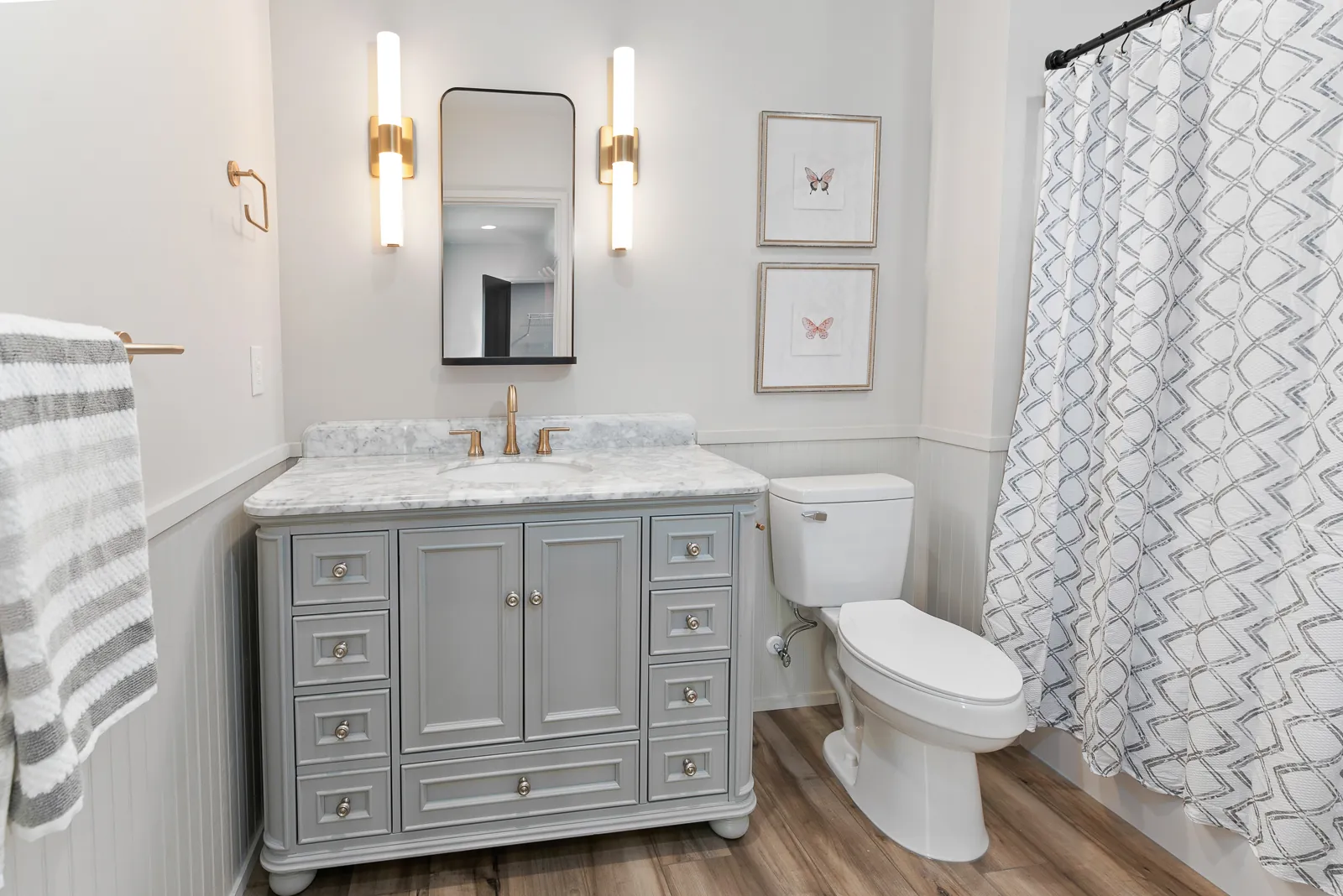 Full bathroom with gray vanity and marble top in the Otter River Home