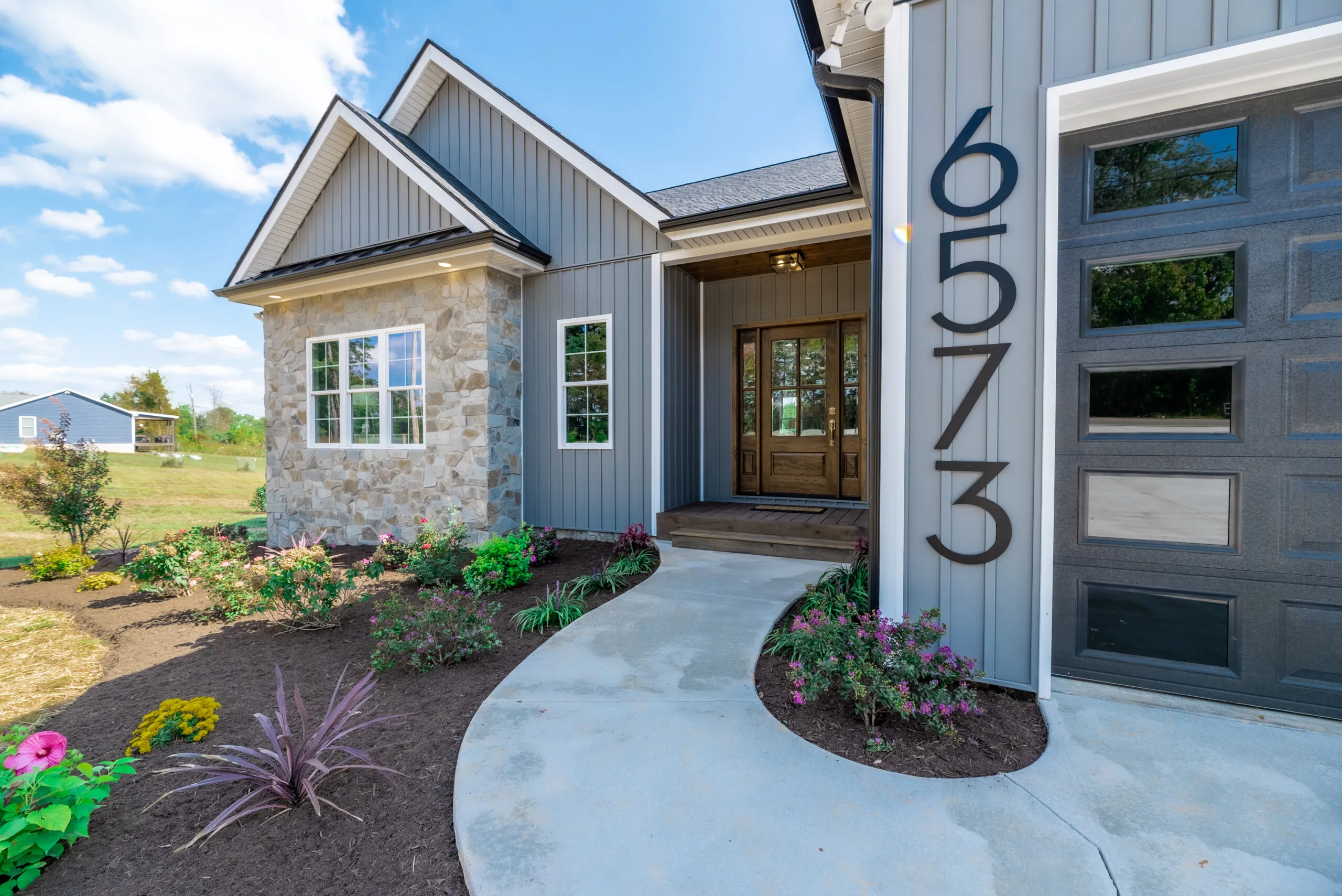 Walkway to front entry of the Otter River Home with landscaping
