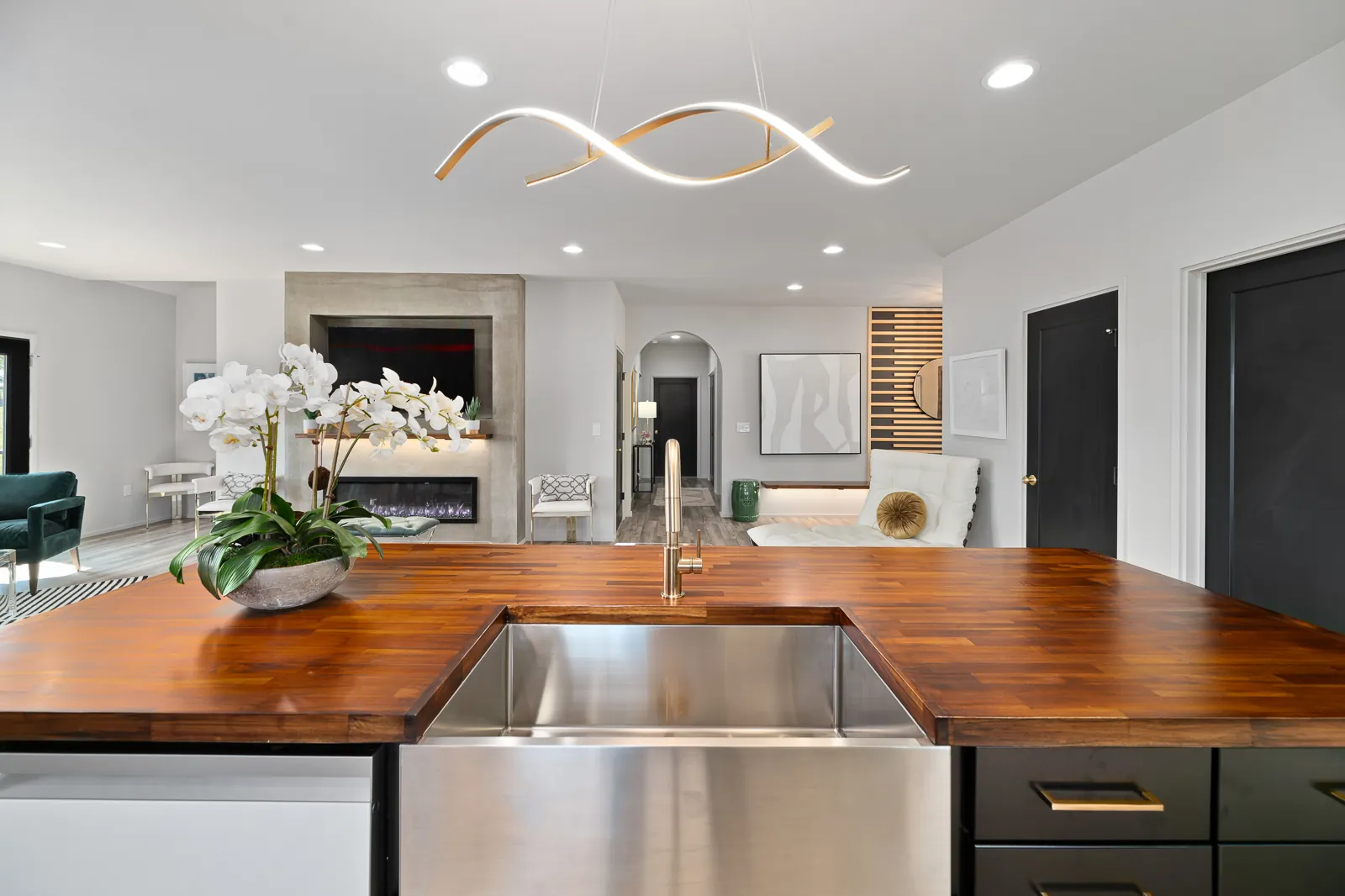 Kitchen island farmhouse sink and open living area in the Otter River Home