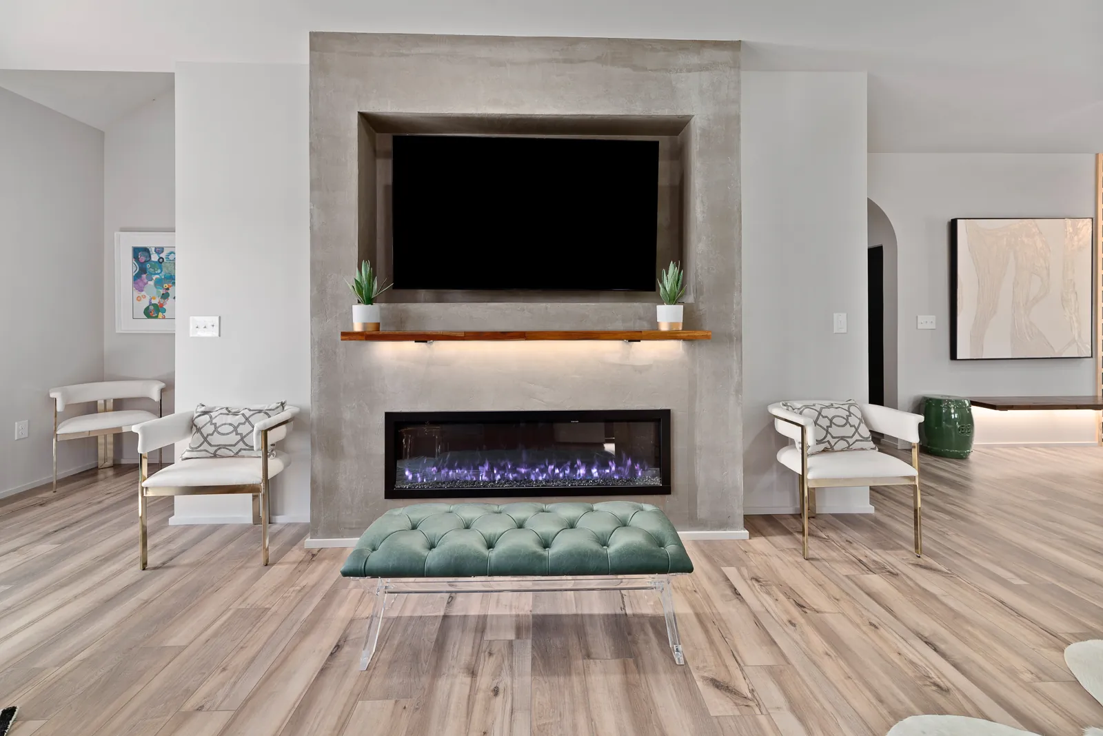 Living room fireplace with wood mantel and TV in the Otter River Home