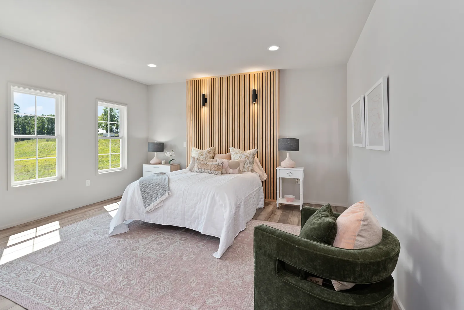 Primary bedroom with wood slat accent wall in the Otter River Home