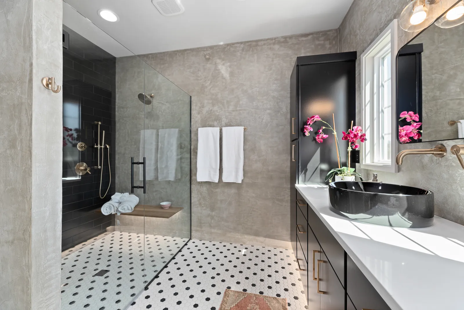 Primary bathroom with walk-in shower and vessel sink in the Otter River Home